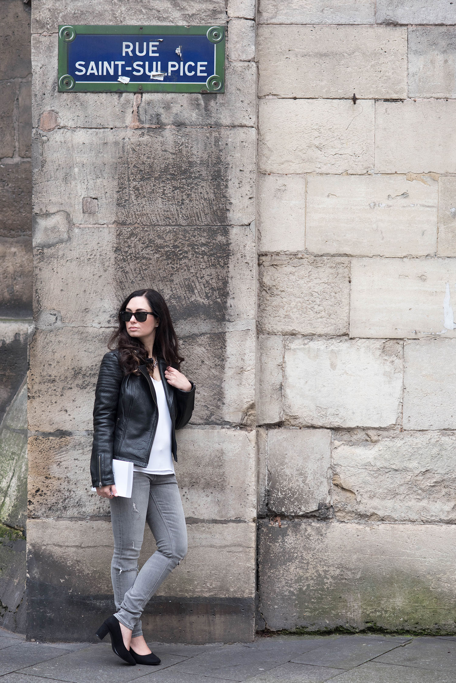Personal style blogger Cee Fardoe of Coco & Vera stands on rue Saint-Sulpice wearing a Cupcakes & Cashmere jacket