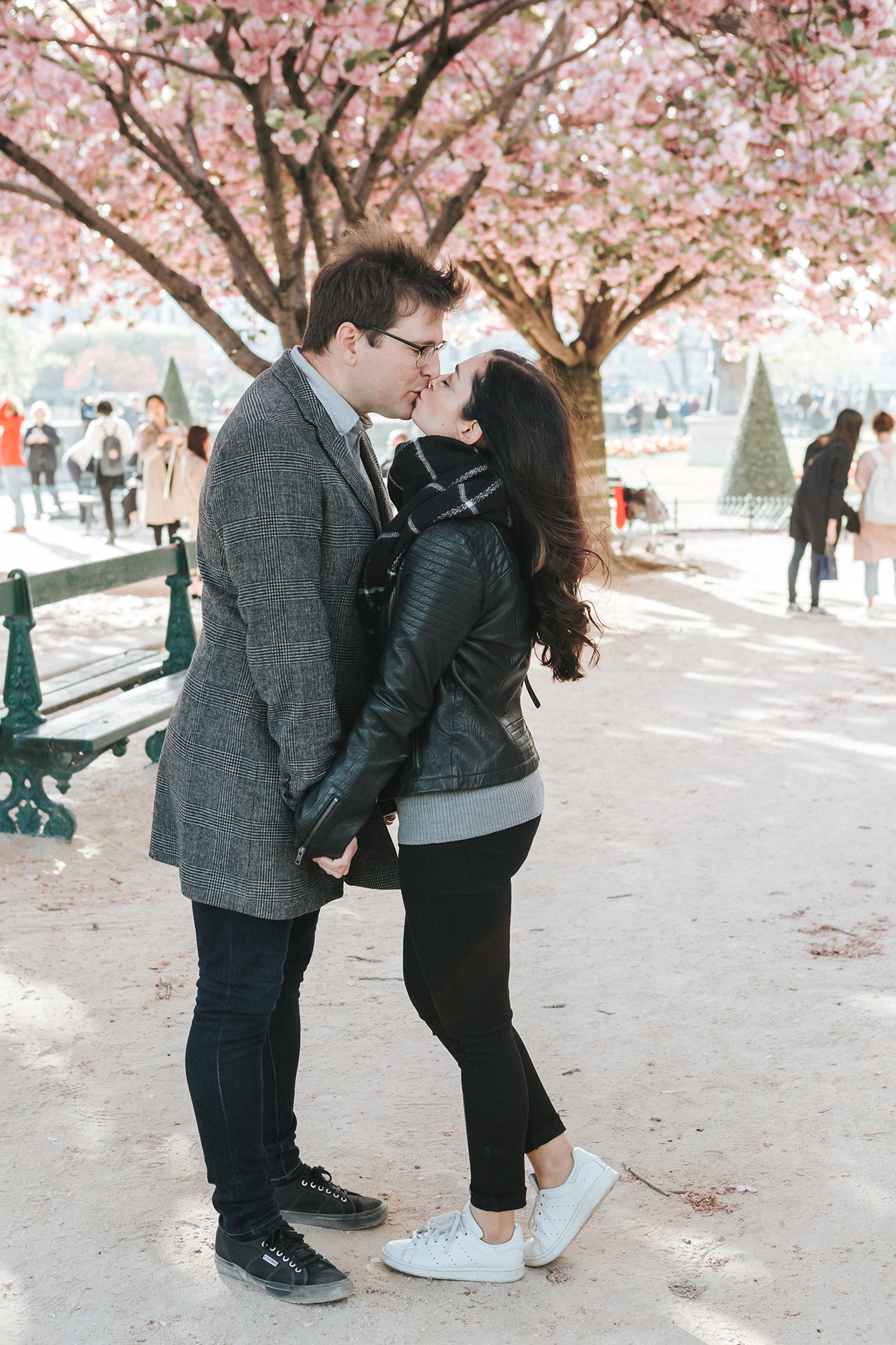 Fashion blogger Cee Fardoe of Coco & Vera kisses her partner under a cherry blossom tree