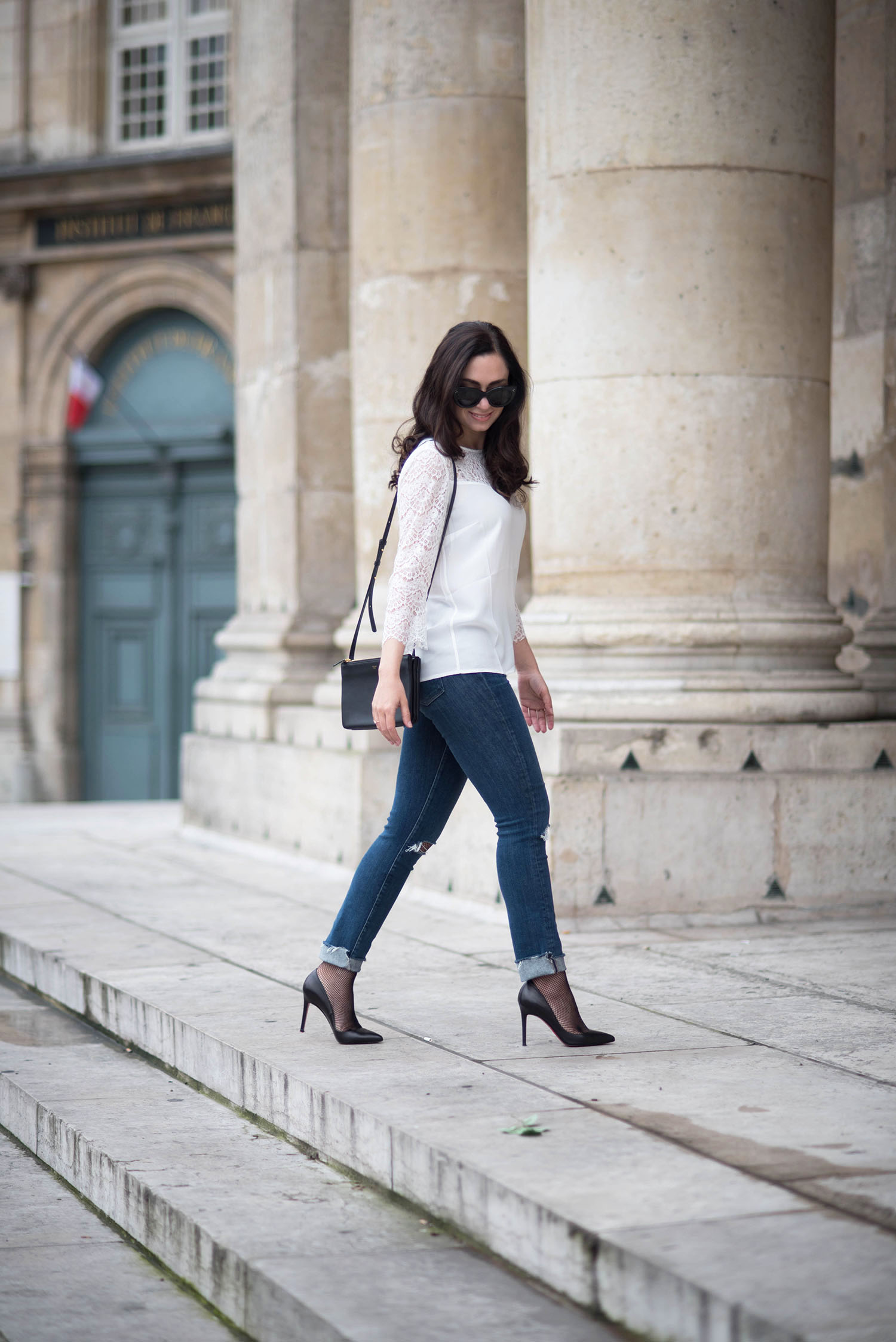 Fashion blogger Cee Fardoe of Coco & Vera walks at the Institut de France wearing Christian Louboutin heels and a Sezane blouse