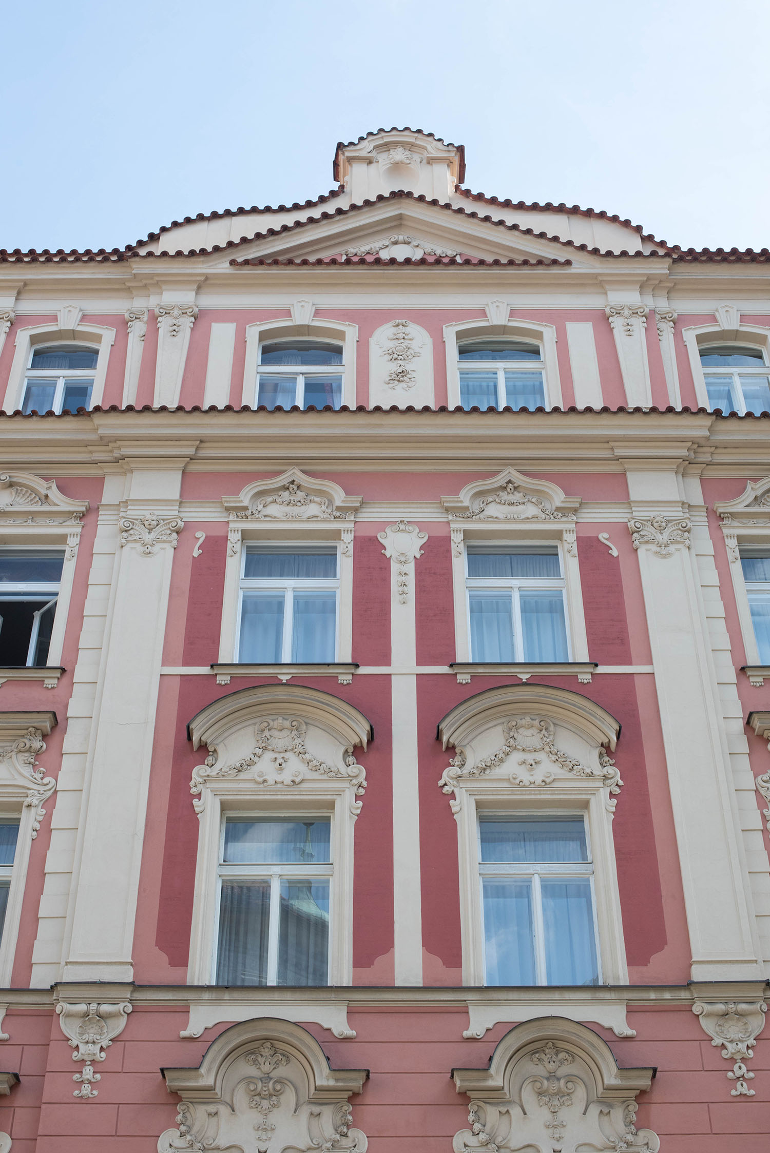 Pink and cream building in the old town of Prague, photographed by travel blogger Cee Fardoe of Coco & Vera