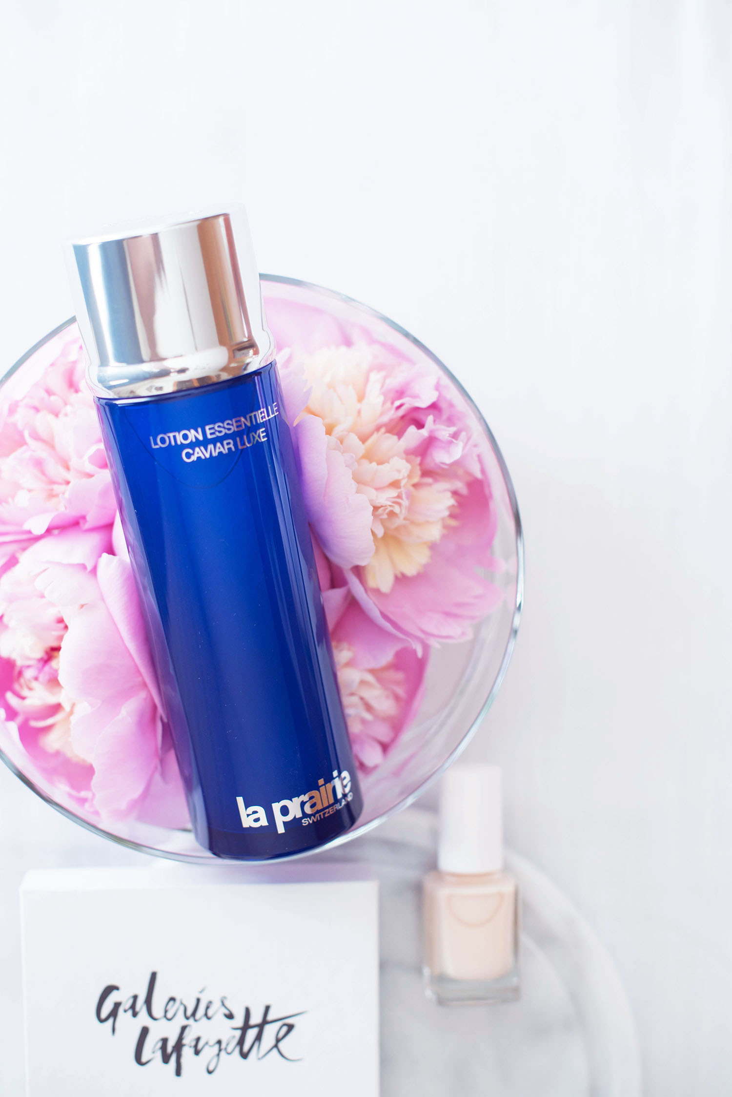La Prairie skin caviar essence in lotion in a bowl of peonies, captured by beauty blogger Cee Fardoe of Coco & Vera