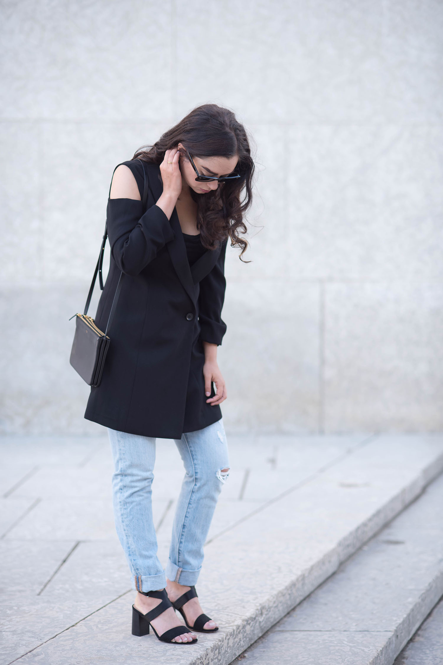 Style blogger Cee Fardoe of Coco & Vera stands wearing Levis 501 skinny jeans and an Ever New coat