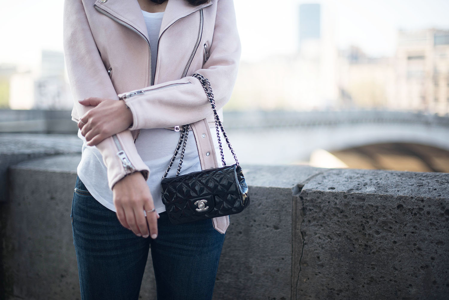 Outfit details on style blogger Coco & Vera, featuring a black Chanel extra mini handbag