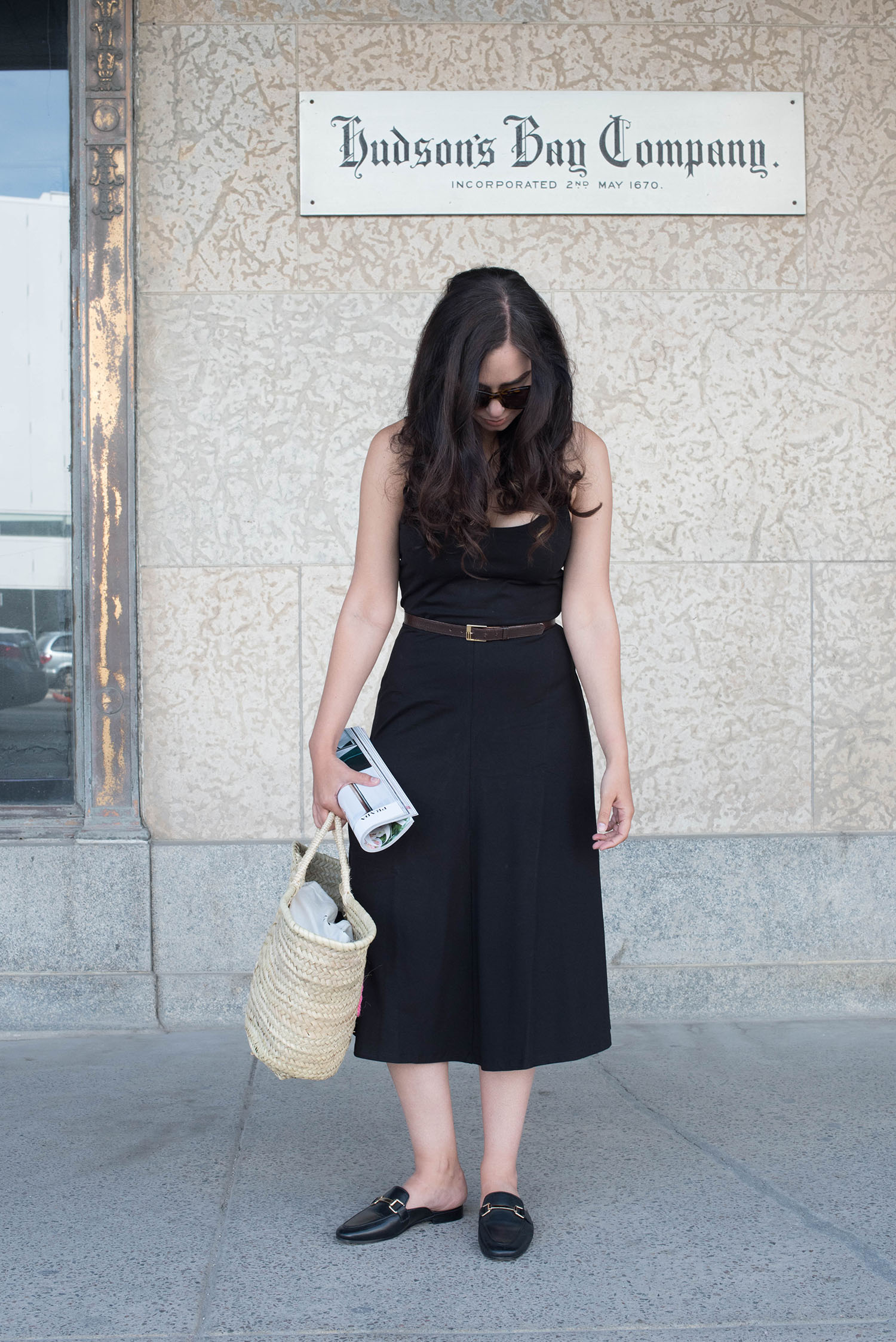 Summer outfit shown by fashion blogger Cee Fardoe of Coco & Vera, featuring a black Privacy Please midi dress and Sezane straw tote