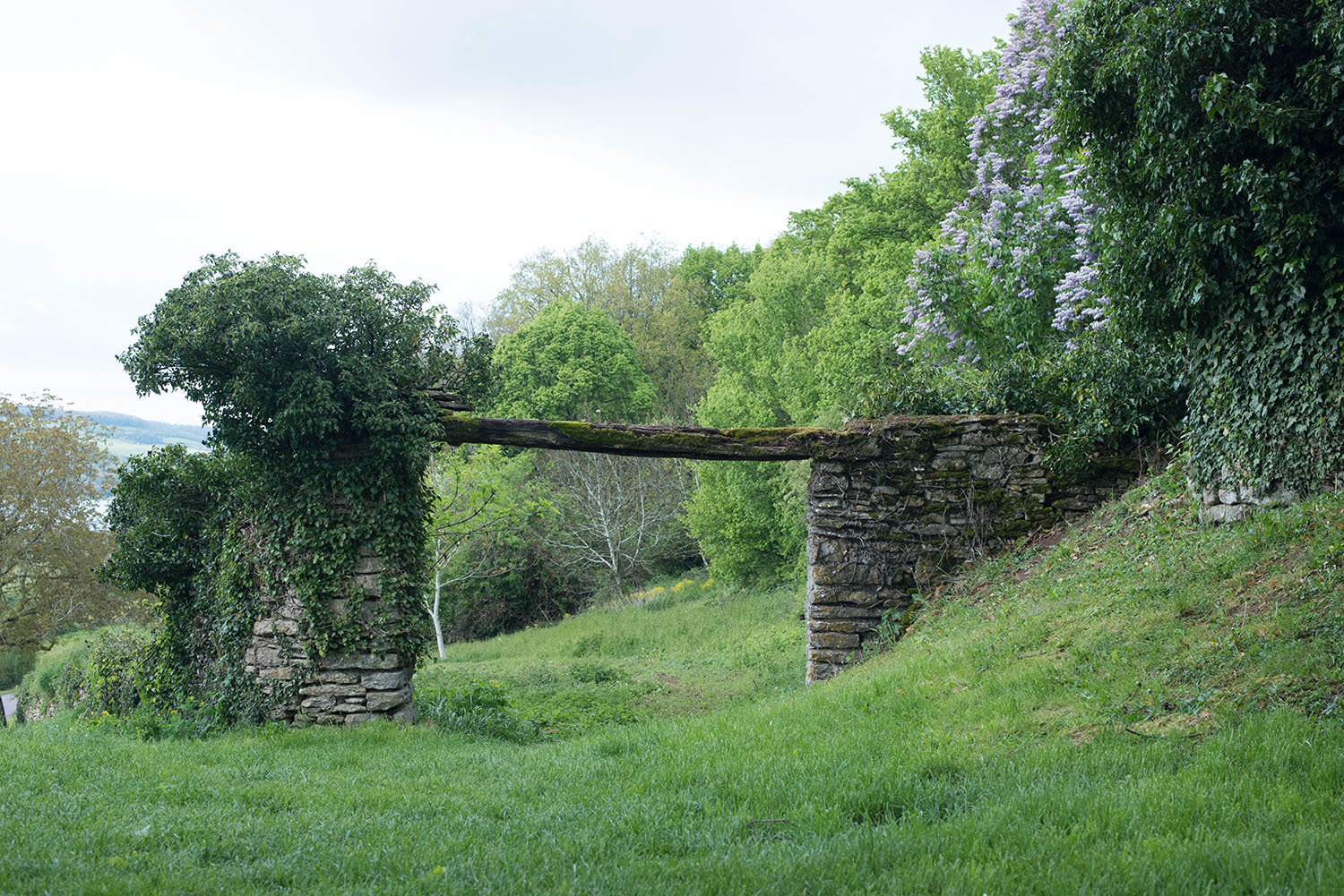 A stone arch on a hill in Burgundy, France, captured by Canadian travel blogger Cee Fardoe of Coco & Vera