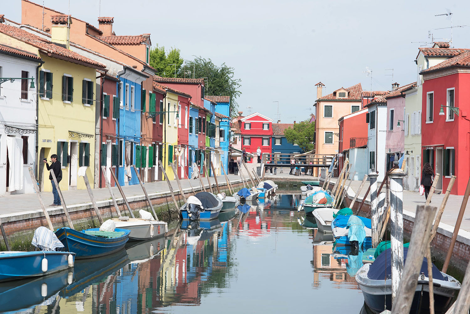 Brightly coloured houses line the canal on the island of Burano in Italy, captured by travel blogger Cee Fardoe of Coco & Vera