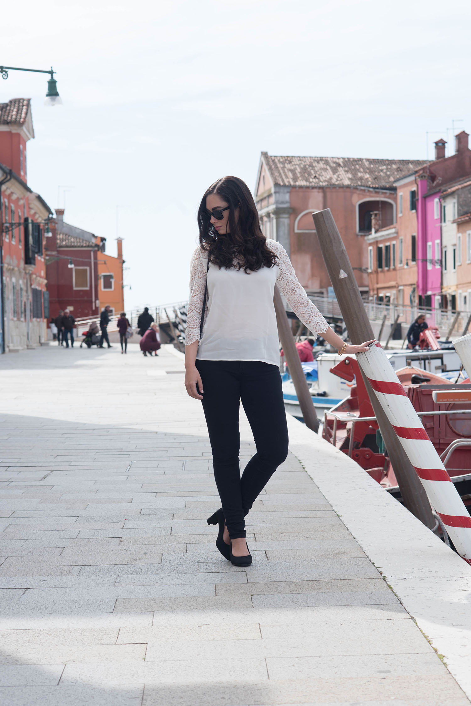 Fashion blogger Cee Fardoe of Coco & Vera on Burano island wearing a Sezane blouse and black Mavi skinny jeans