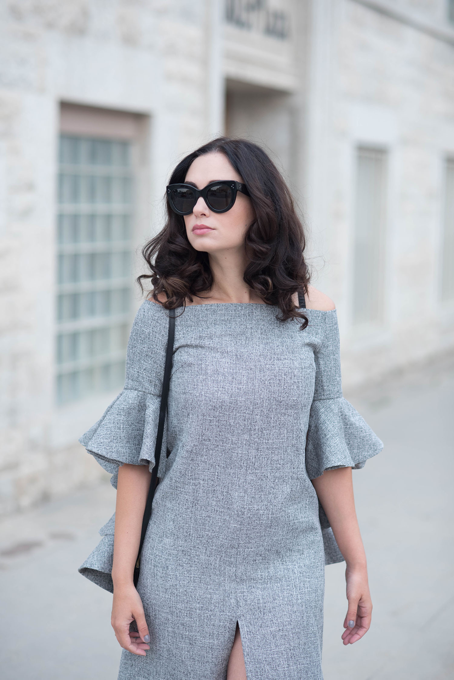 Portrait of Winnipeg fashion blogger Cee Fardoe of Coco & Vera wearing Celine Audrey sunglasses and a grey dress