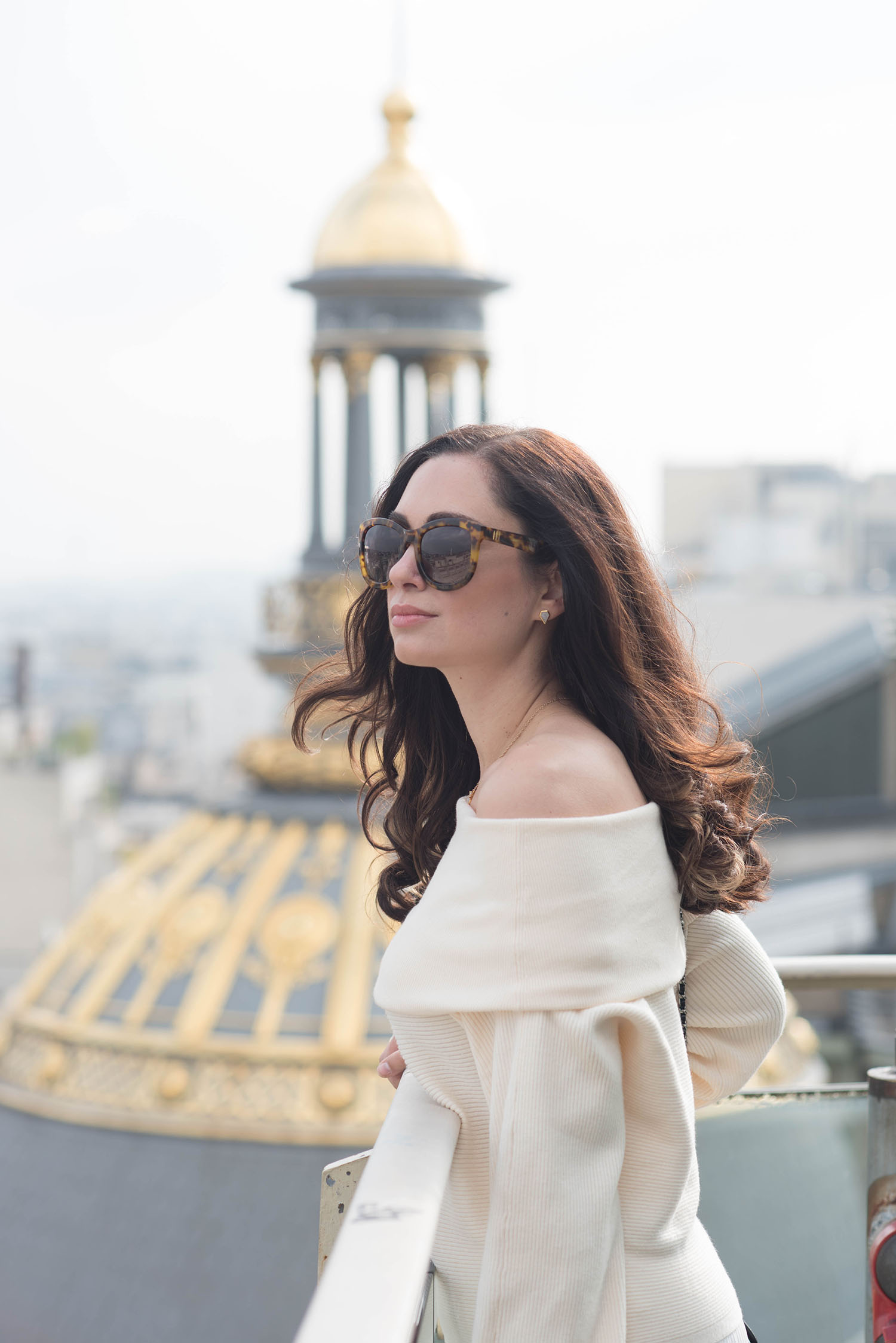 Portrait of Winnipeg fashion blogger Cee Fardoe of Coco & Vera looking out over Paris wearing Anine Bing Paris sunglasses