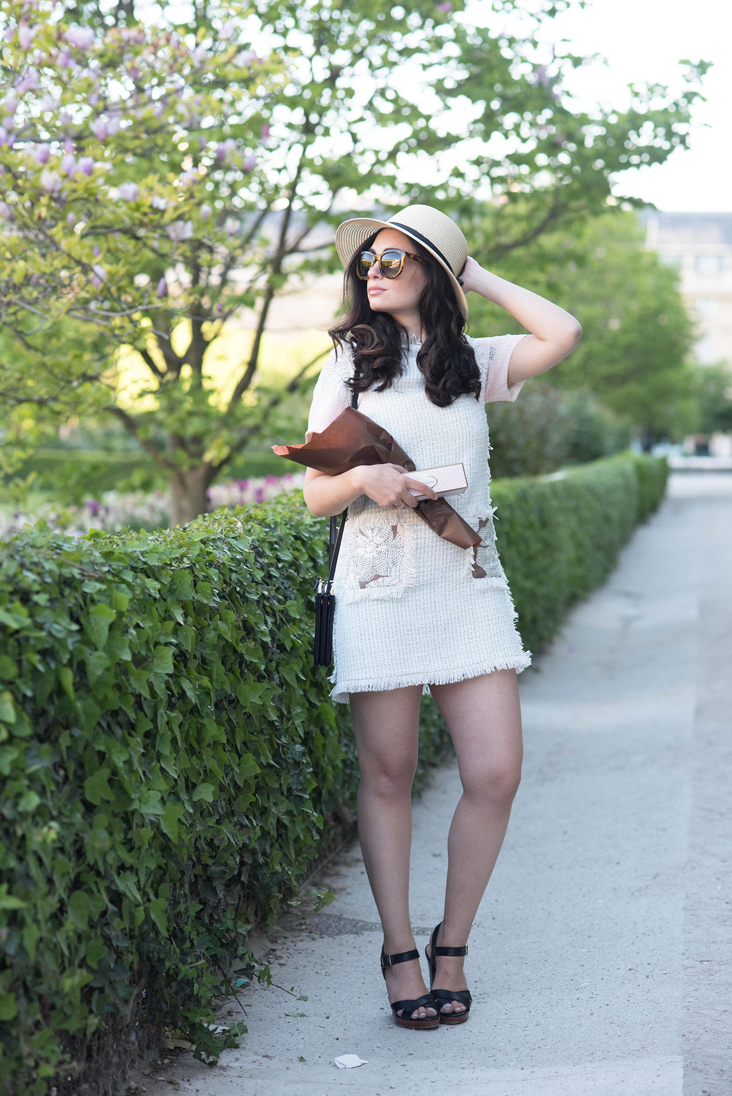 Fashion blogger Cee Fardoe of Coco & Vera in the Palais Royal garden in Paris wearing a Floriane Fosso dress and Anine Bing sunglasses