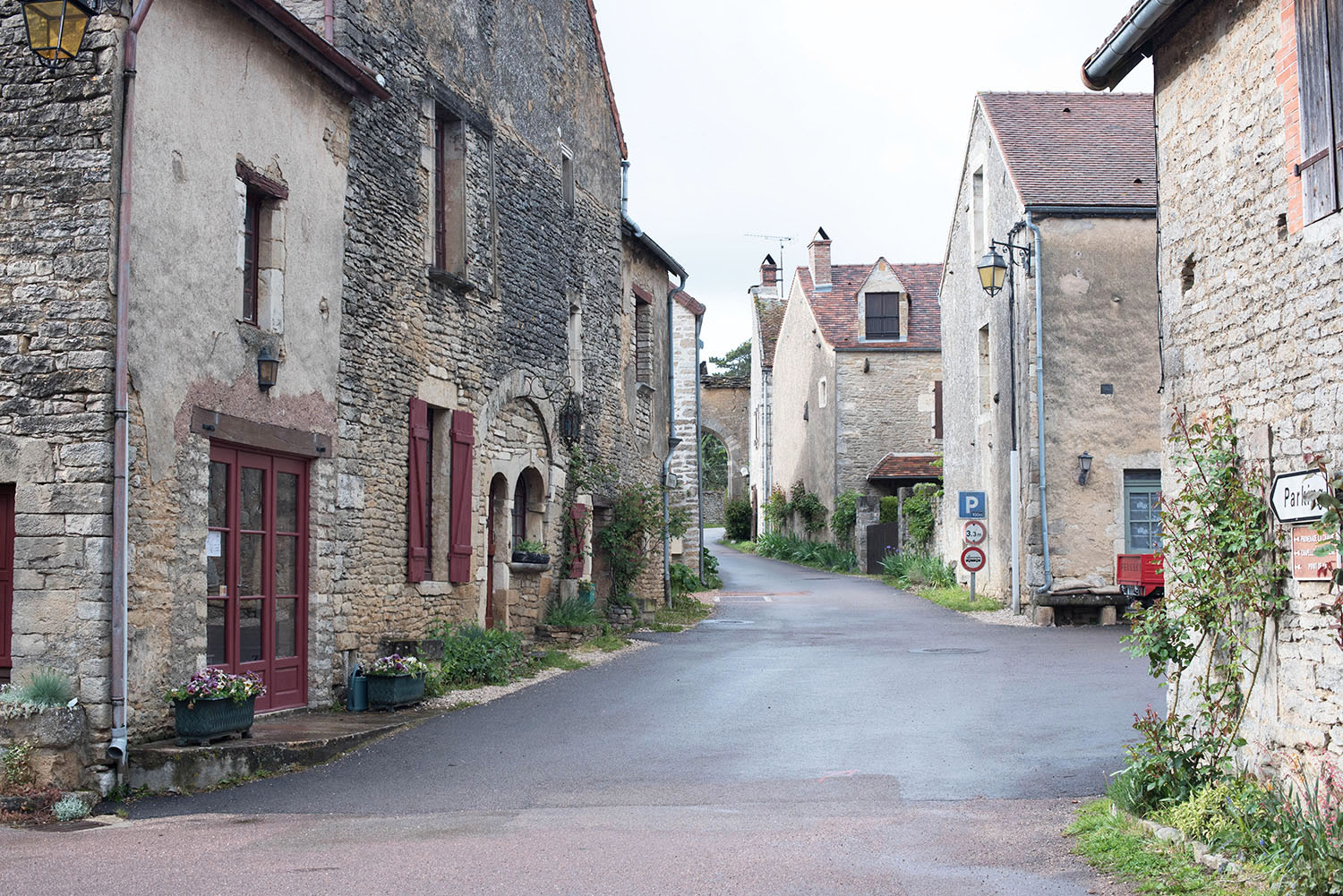 Stone houses in the town of Chateauneuf-en-Auxois in Burgundy, photographed by travel blogger Cee Fardoe of Coco & Vera