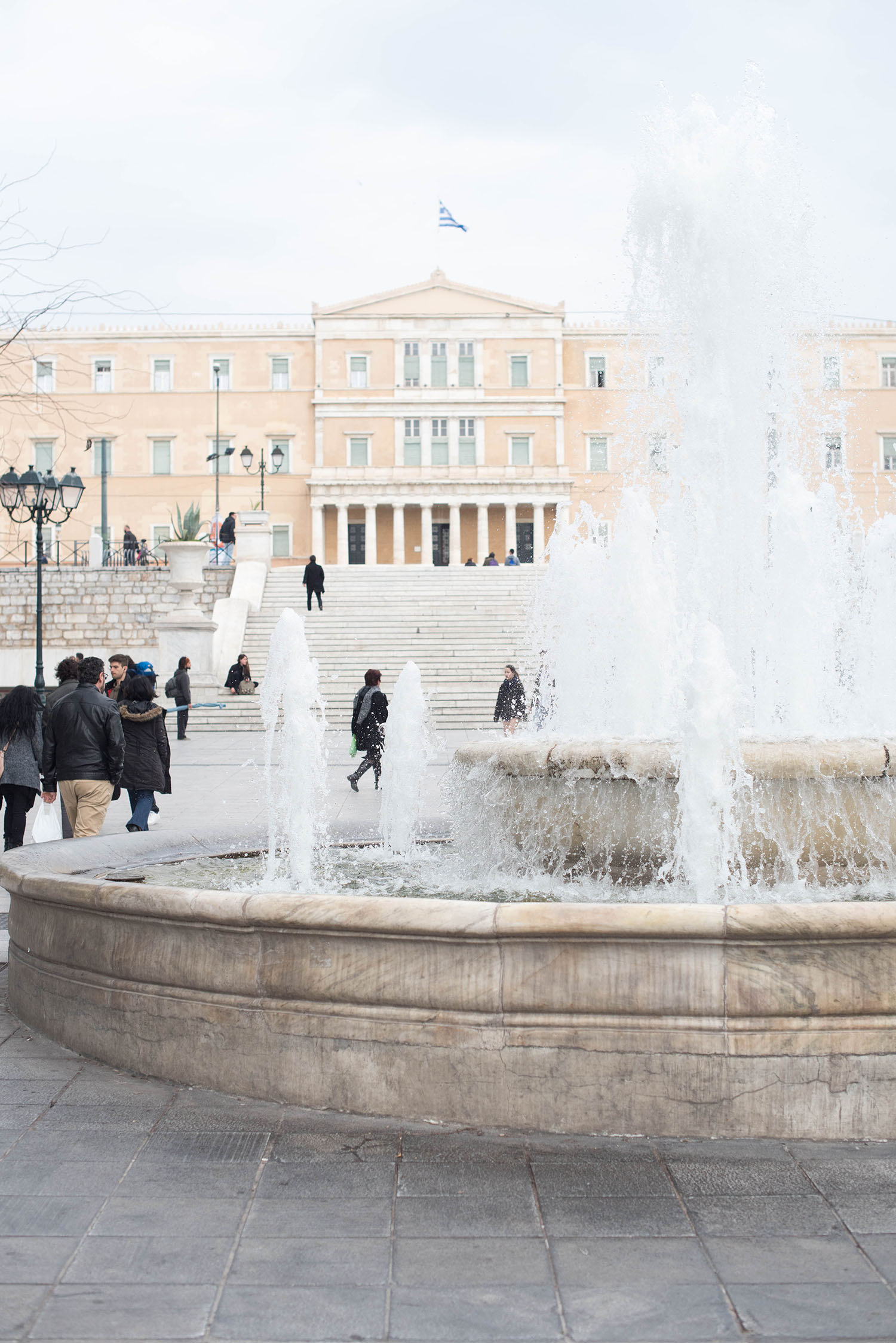 The University of Athens seen through the fountain at Syntagma Square in the Greek capital, as captured by travel blogger Cee Fardoe of Coco & Vera