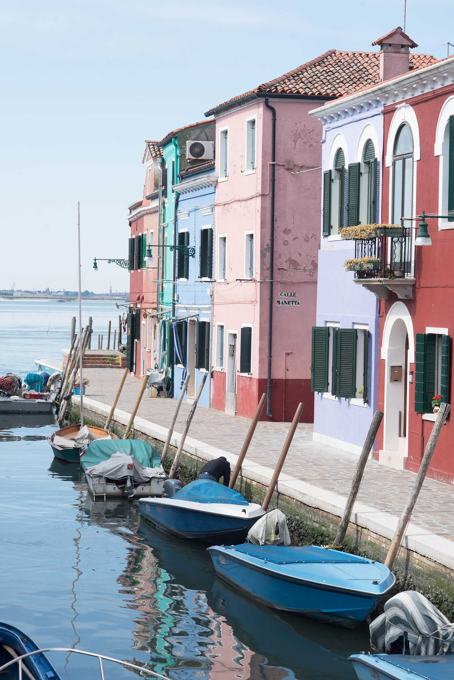 Pastel houses line the canal in Burano, Italy, captured by travel blogger Cee Fardoe of Coco & Vera