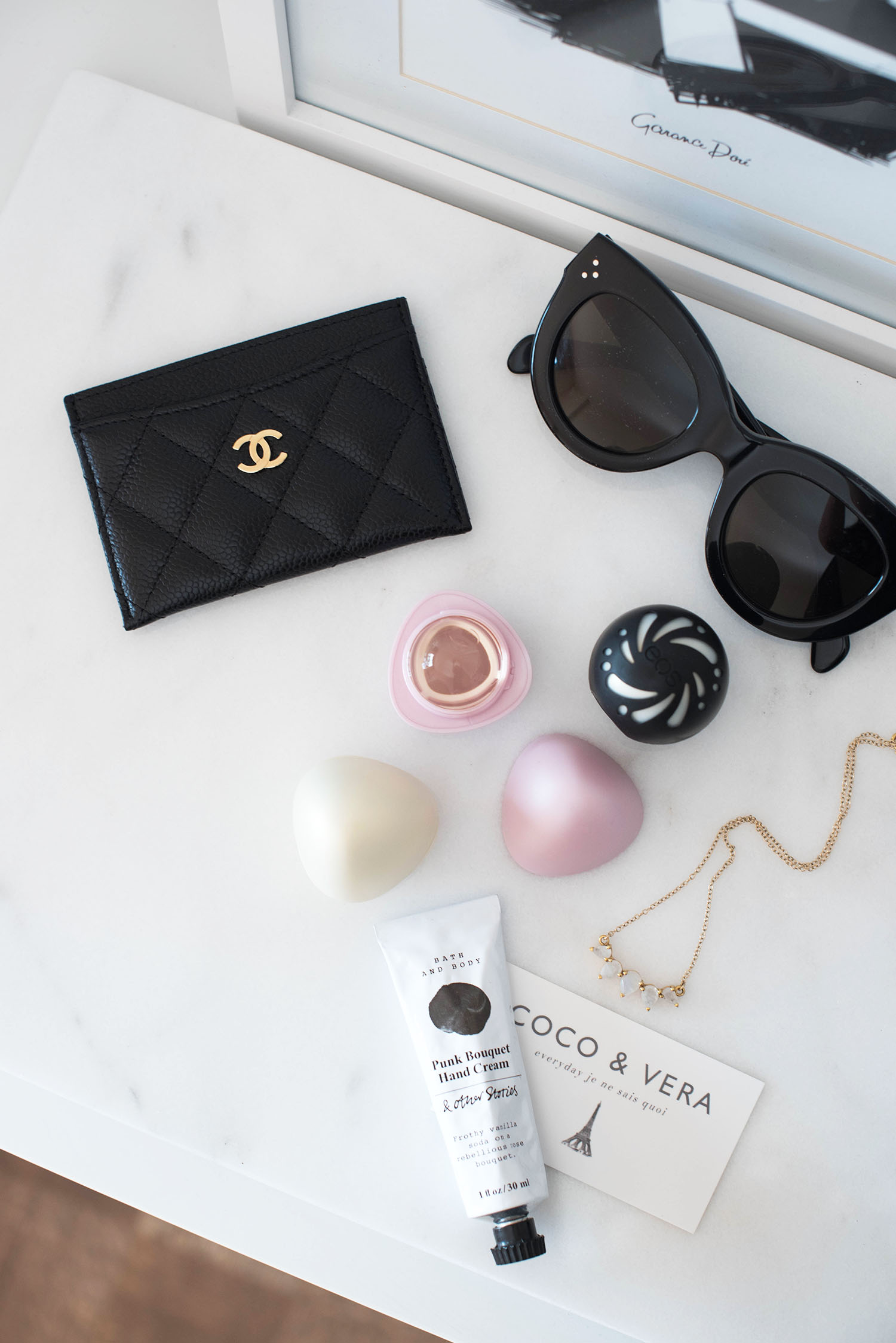 Flatly featuring EOS crystal lip balm, a Chanel cardholder owned by fashion blogger Cee Fardoe of Coco & Vera, and Celine Audrey sunglasses