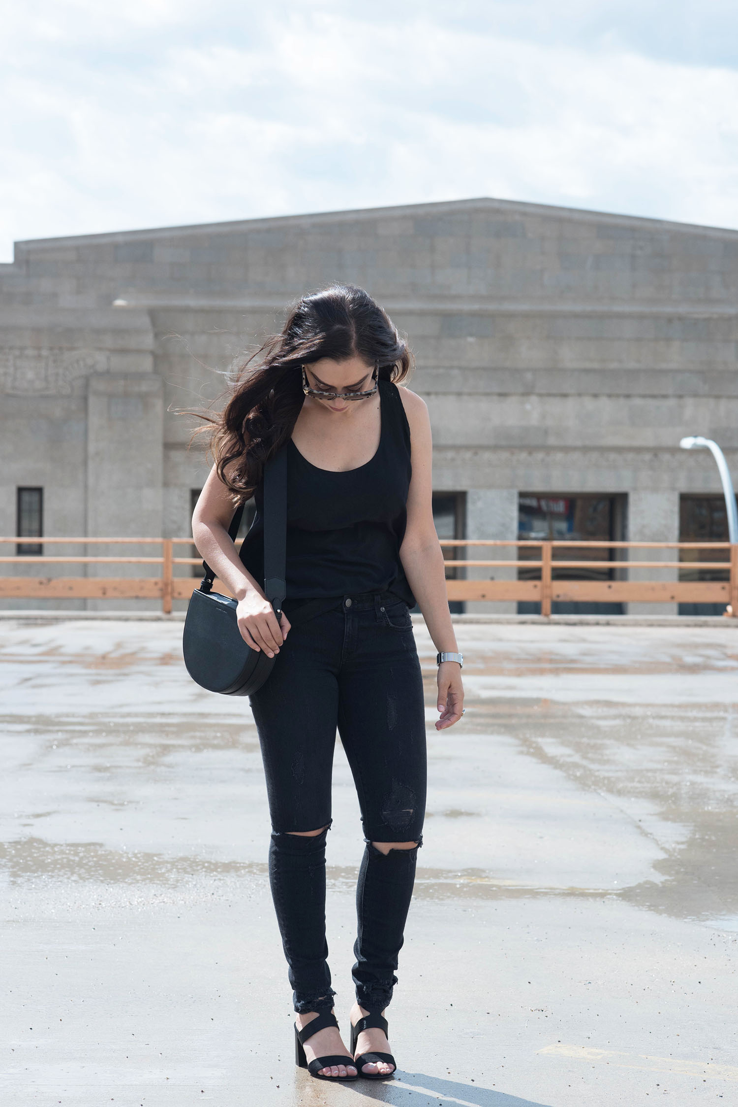 A simple all black everything outfit on fashion blogger Cee Fardoe of Coco & Vera, including Lovers + Friends jeans and a Charles & Keith bag