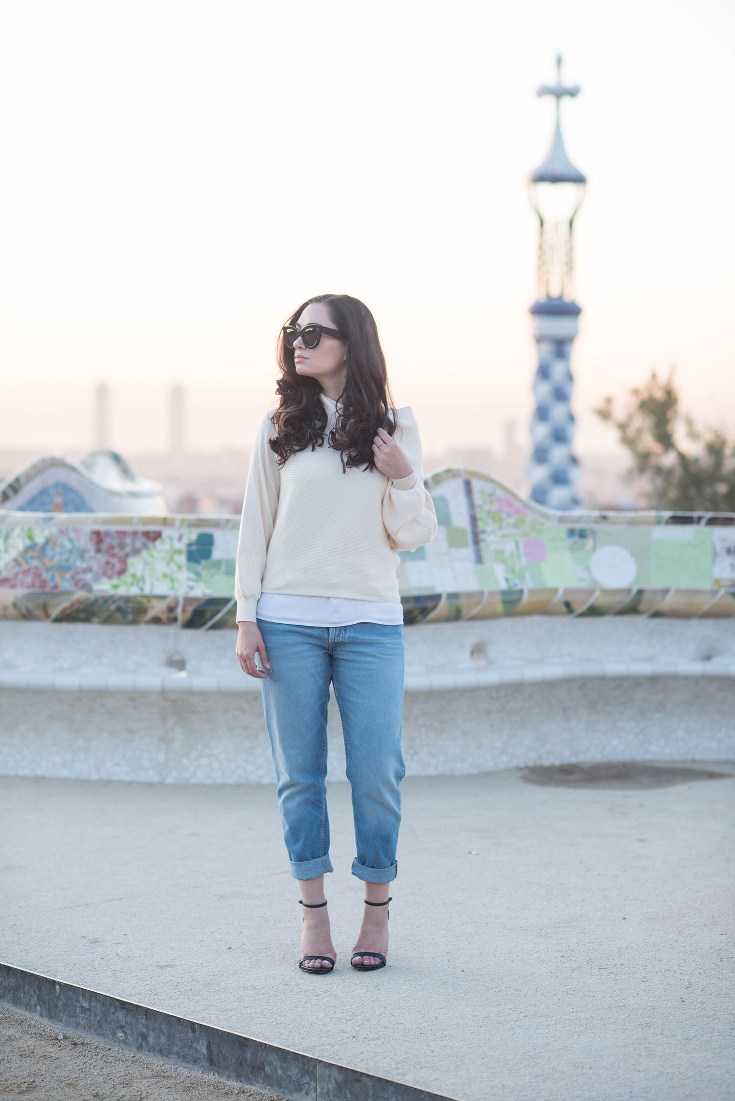 Winnipeg fashion blogger Cee Fardoe of Coco & Vera stands at Parc Guell in Barcelona wearing a Zara blush sweater and Steve Madden Stecy sandals