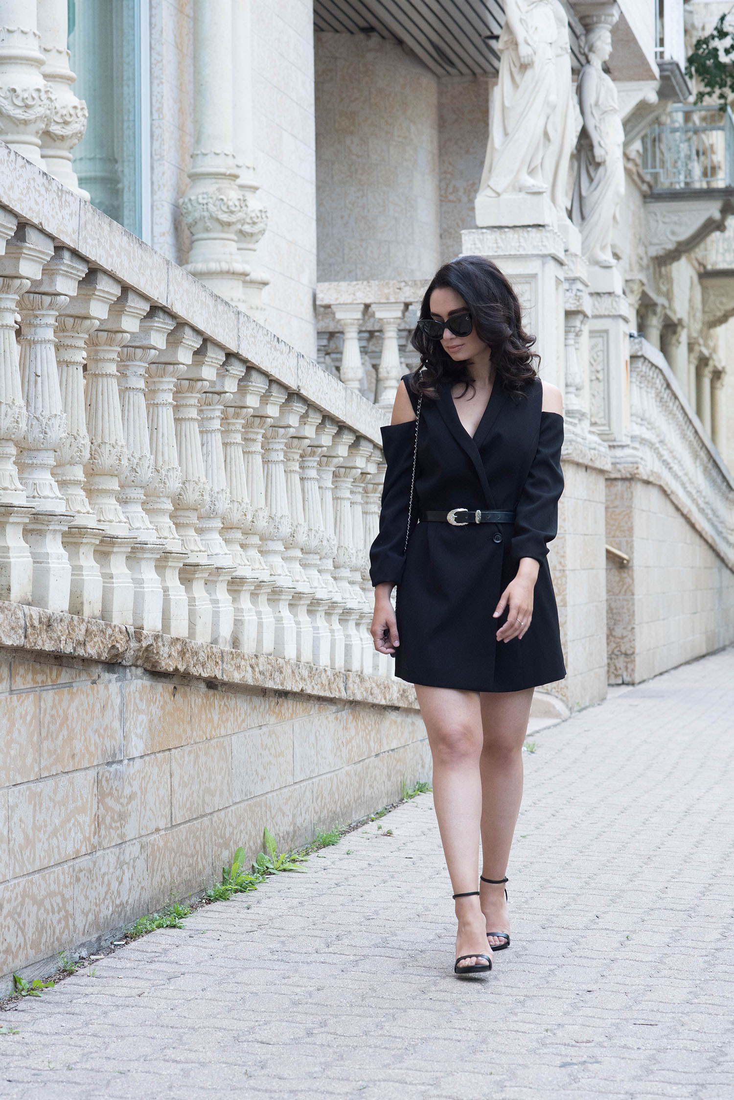 Fashion blogger Cee Fardoe of Coco & Vera walks past Fort Garry Place in Winnipeg wearing an Ever New dress, Steve Madden sandals and vintage belt