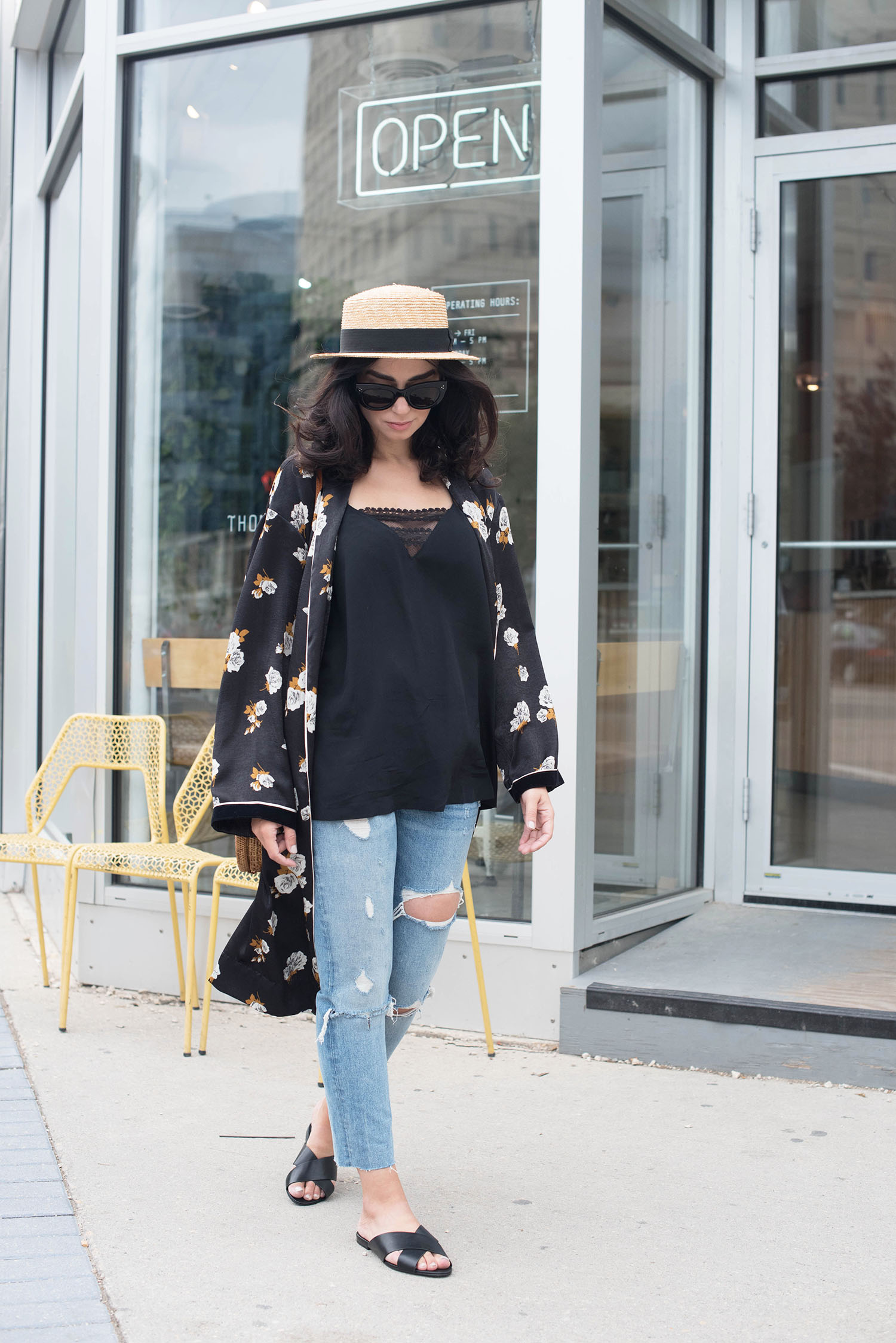 Winnipeg fashion blogger Cee Fardoe of Coco & Vera walks in front of Thom Bargen coffee shop wearing a Zara floral kimono and Grlfrnd Karolina jeans