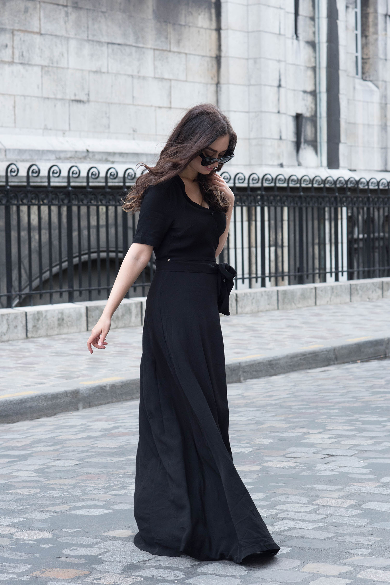 Winnipeg fashion blogger Cee Fardoe of Coco & Vera walks in Montmartre wearing a black Ivy & Oak wrap dress