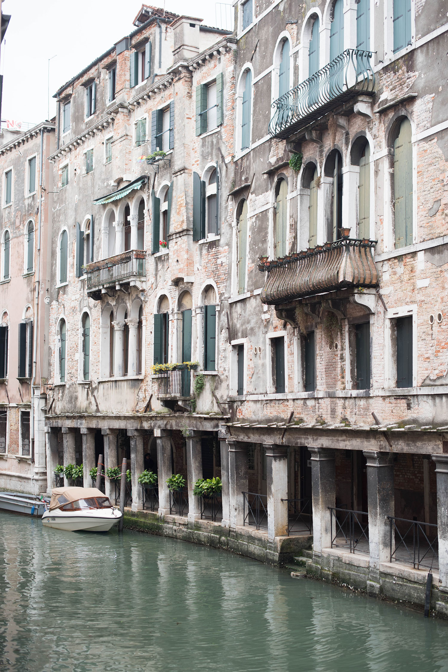 Typical white and green canal-side homes in Venice, Italy, as captured by travel blogger Cee Fardoe of Coco & Vera