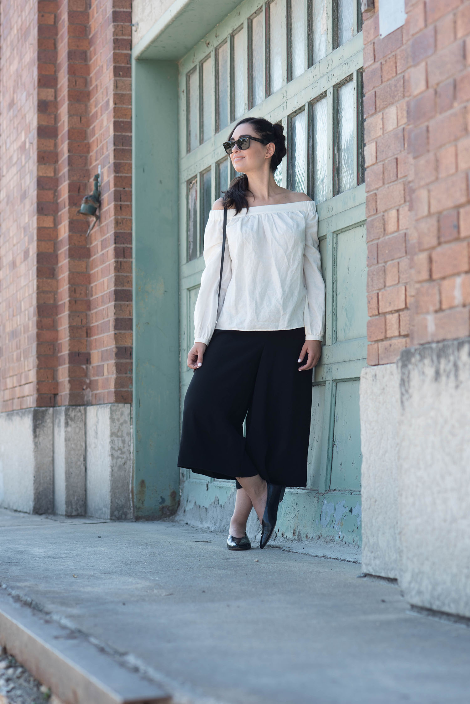 Fashion blogger Cee Fardoe of Coco & Vera wears a braid by Fran Rizzutto with Aritzia culottes and white off-shoulder blouse