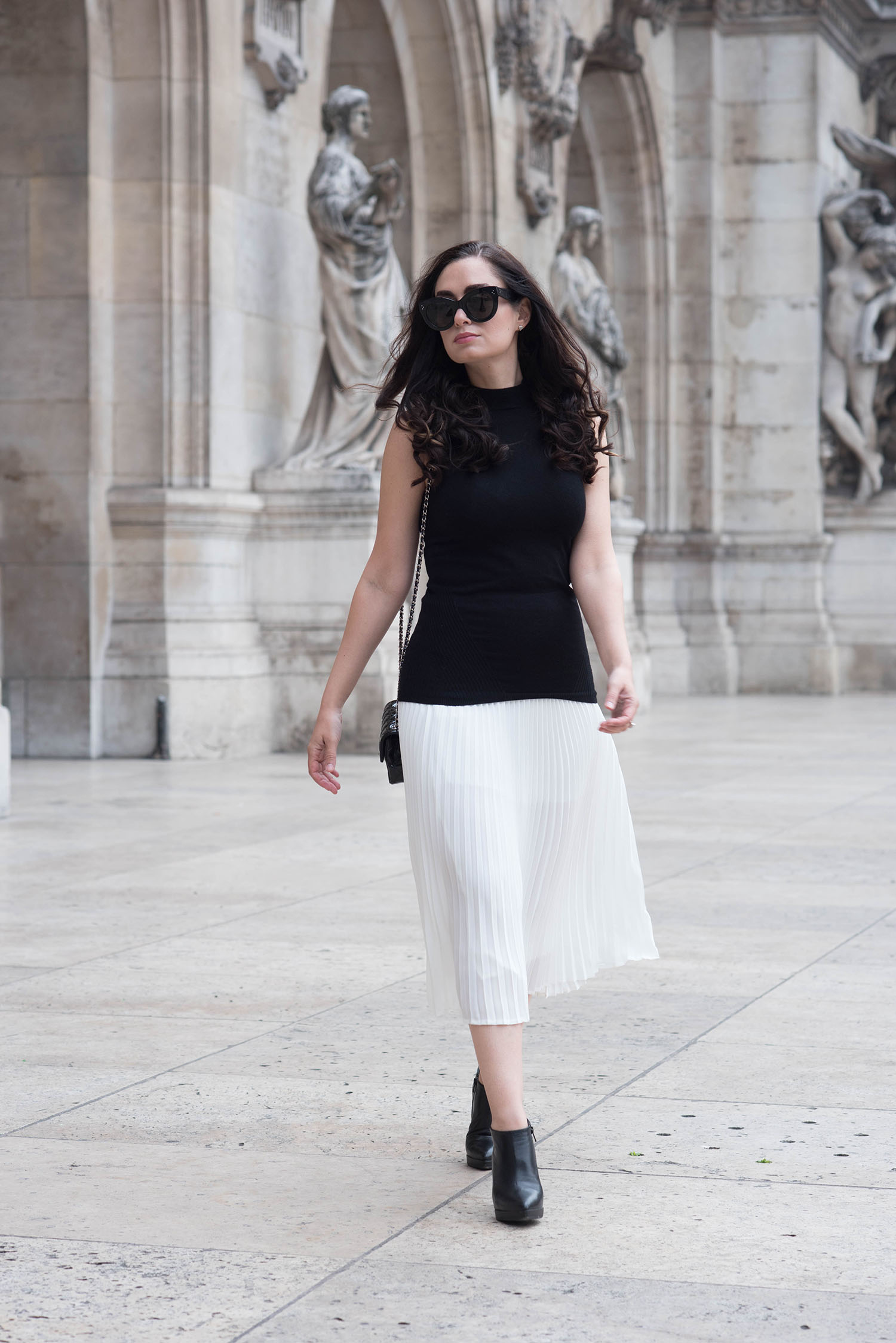 Fashion blogger Cee Fardoe of Coco & Vera at Opera Garner in Paris wearing a white pleated Aritzia skirt and Celine Audrey sunglasses