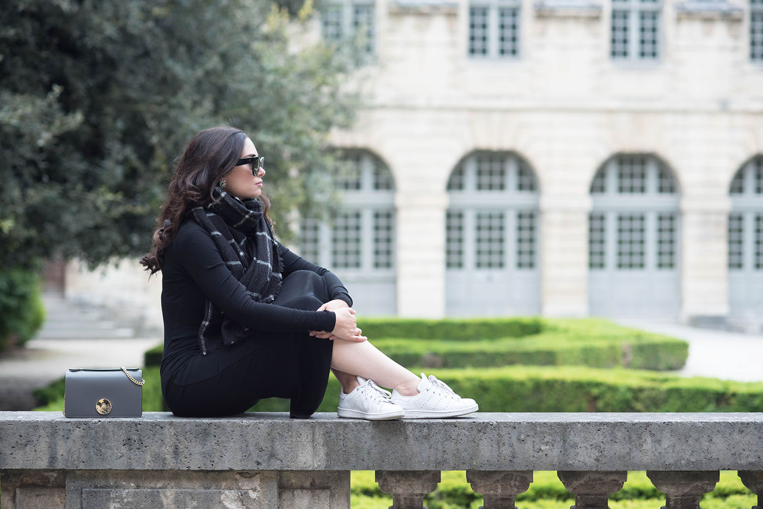 Winnipeg fashion blogger Cee Fardoe of Coco & Vera sits at the Hotel de Sully in Paris wearing a Privacy Please midway dress and Zara checked scarf