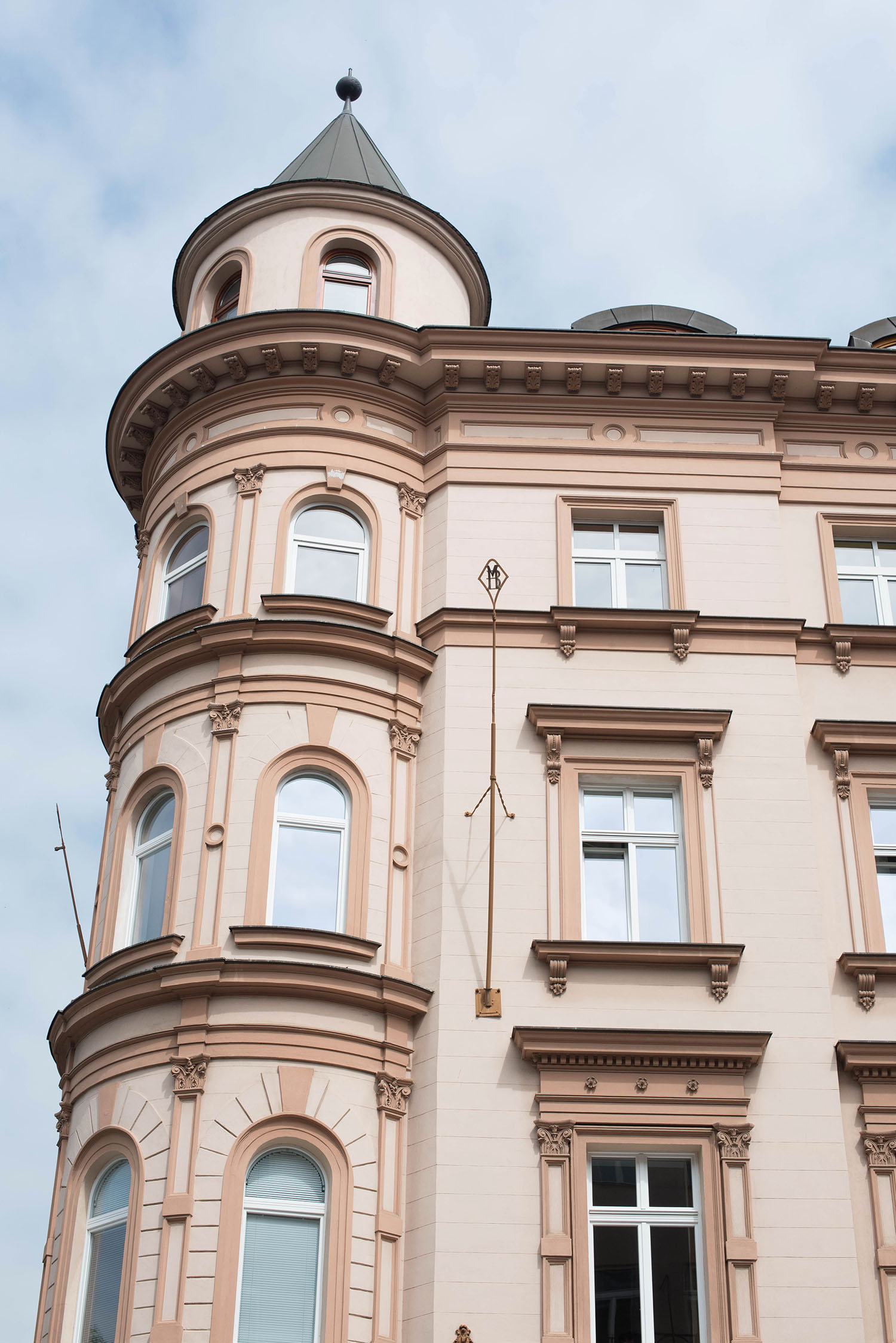 The facade of a pink apartment building in Prague, Czech Republic, as captured by travel blogger Cee Fardoe of Coco & Vera