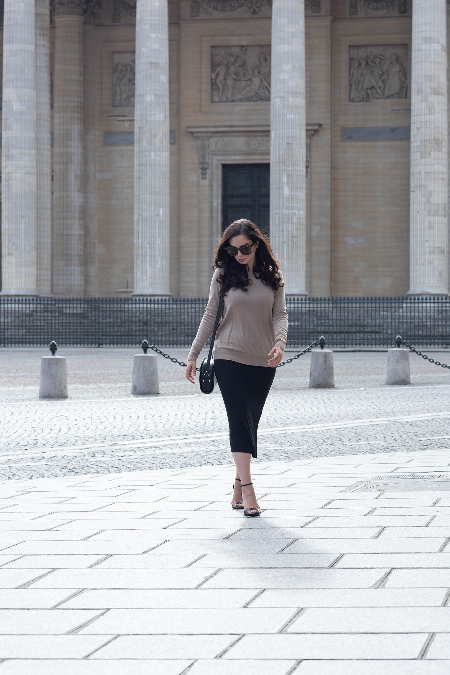 Fashion blogger Cee Fardoe of Coco & Vera walks away from the Pantheon in Paris wearing a Privacy Please dress and carrying an APC halfmoon bag