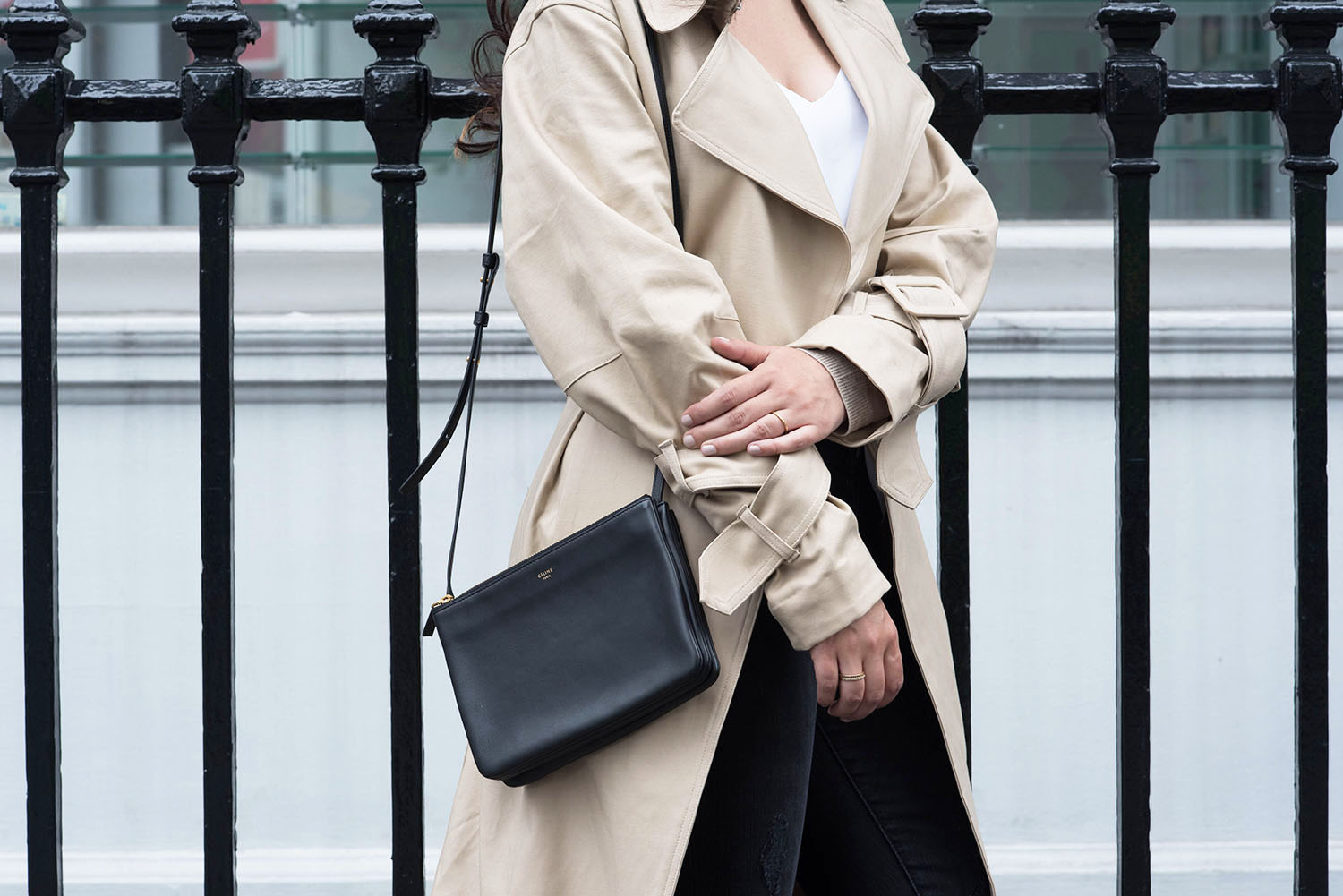 Outfit details on fashion blogger Cee Fardoe of Coco & Vera, wearing an H&M trench coat and carrying a black Celine trio bag