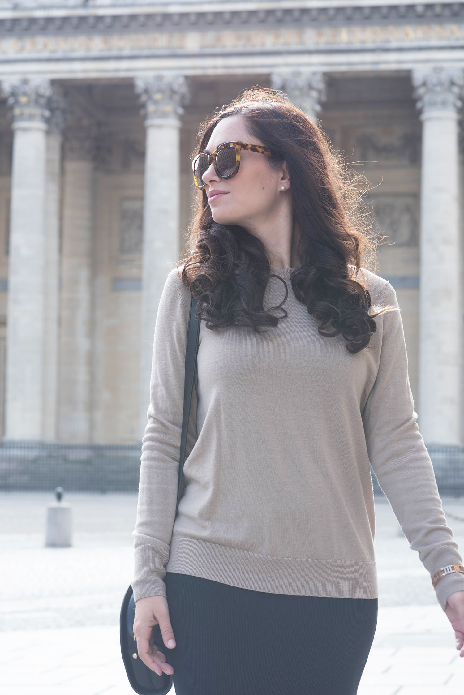Portrait of fashion blogger Cee Fardoe of Coco & Vera at the Pantheon in Paris wearing CC Lifestyles pearl earrings and a Uniqlo camel sweater