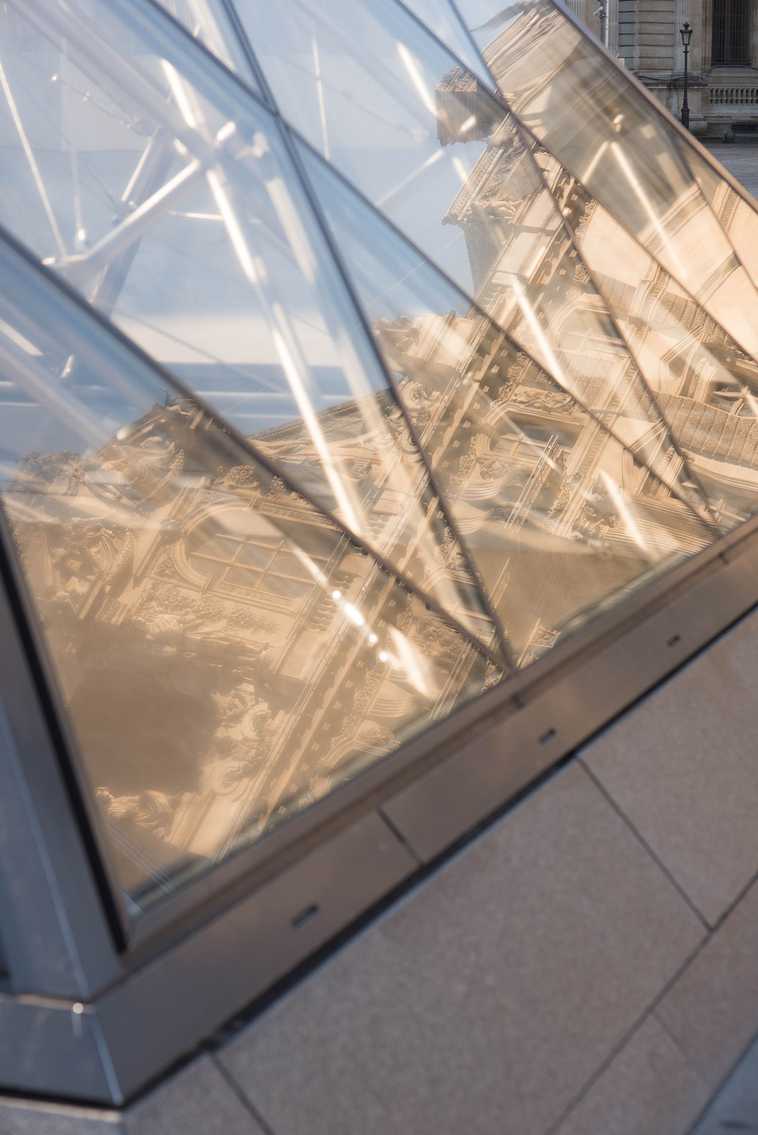 Reflections of the Palais du Louvre in the Louvre Pyramid in Paris, captured by top travel blogger Cee Fardoe of Coco & Vera