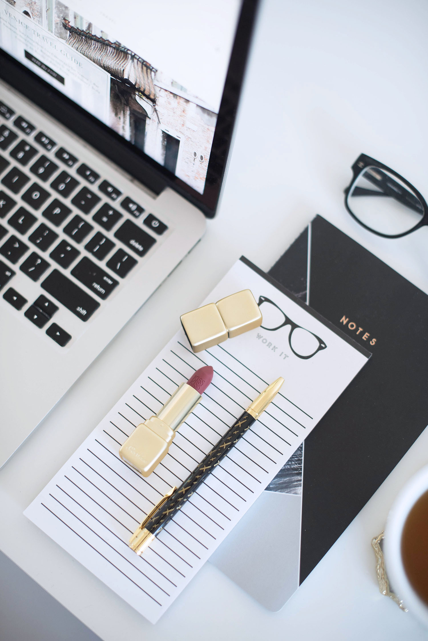 Desk details in the home office of Winnipeg fashion blogger Cee Fardoe of Coco & Vera, including Guerlain lipstick, Chanel glasses and a Jot it Down pen