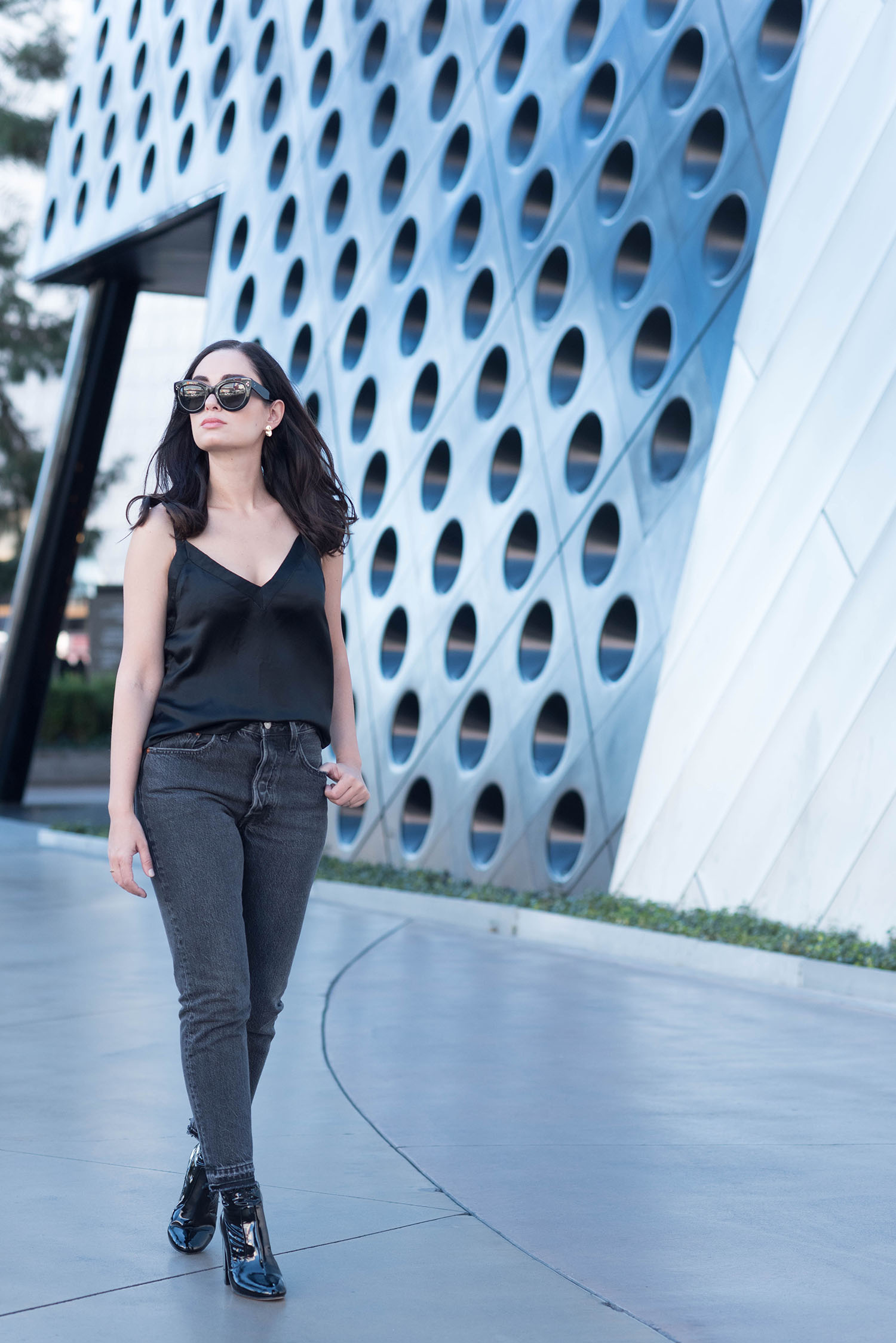 Fashion blogger Cee Fardoe of Coco & Vera walks in Las Vegas wears Levis 501 skinny jeans and Raye black patent boots