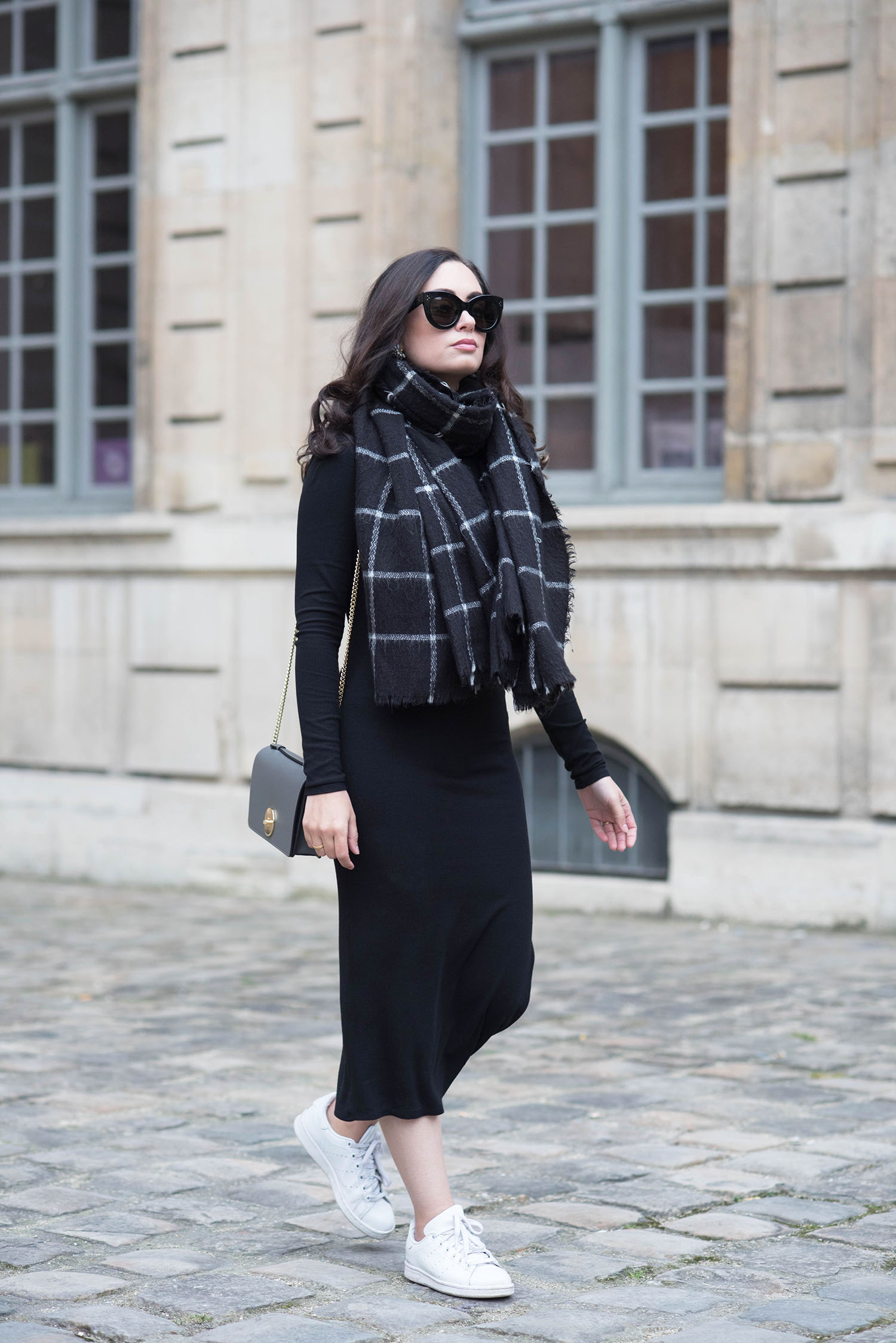 Fashion blogger Cee Fardoe of Coco & Vera walks at the Hotel de Sully in Paris wearing a Privacy Please midway dress and Adidas Stan Smith sneakers