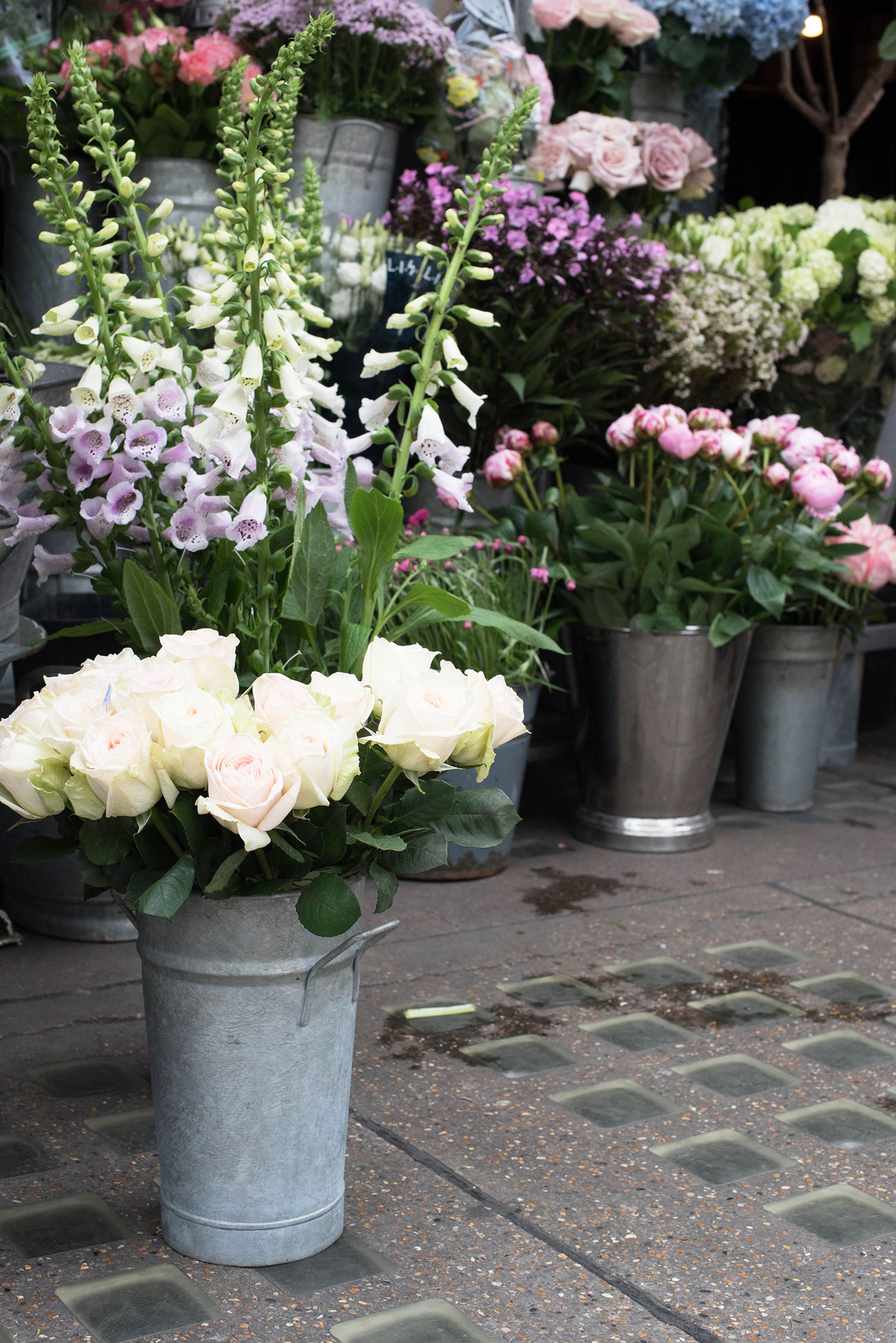 Metal buckets of fresh flowers at Liberty London, as captured by top travel blogger Cee Fardoe of Coco & Vera