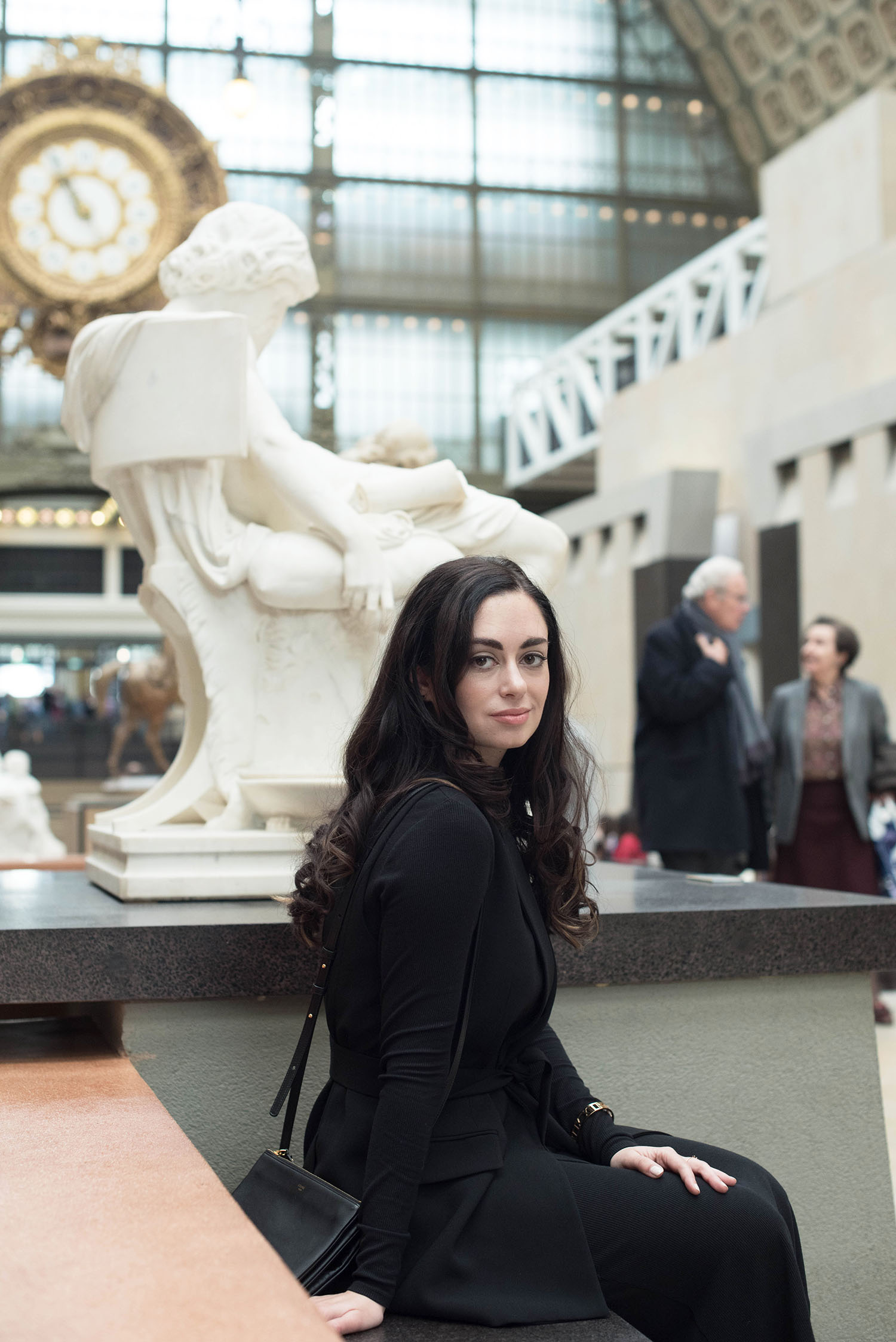 Portrait of brunette fashion blogger Cee Fardoe of Coco & Vera at the Musee d'Orsay in Paris wearing a Zara waistcoat and Celine trio bag