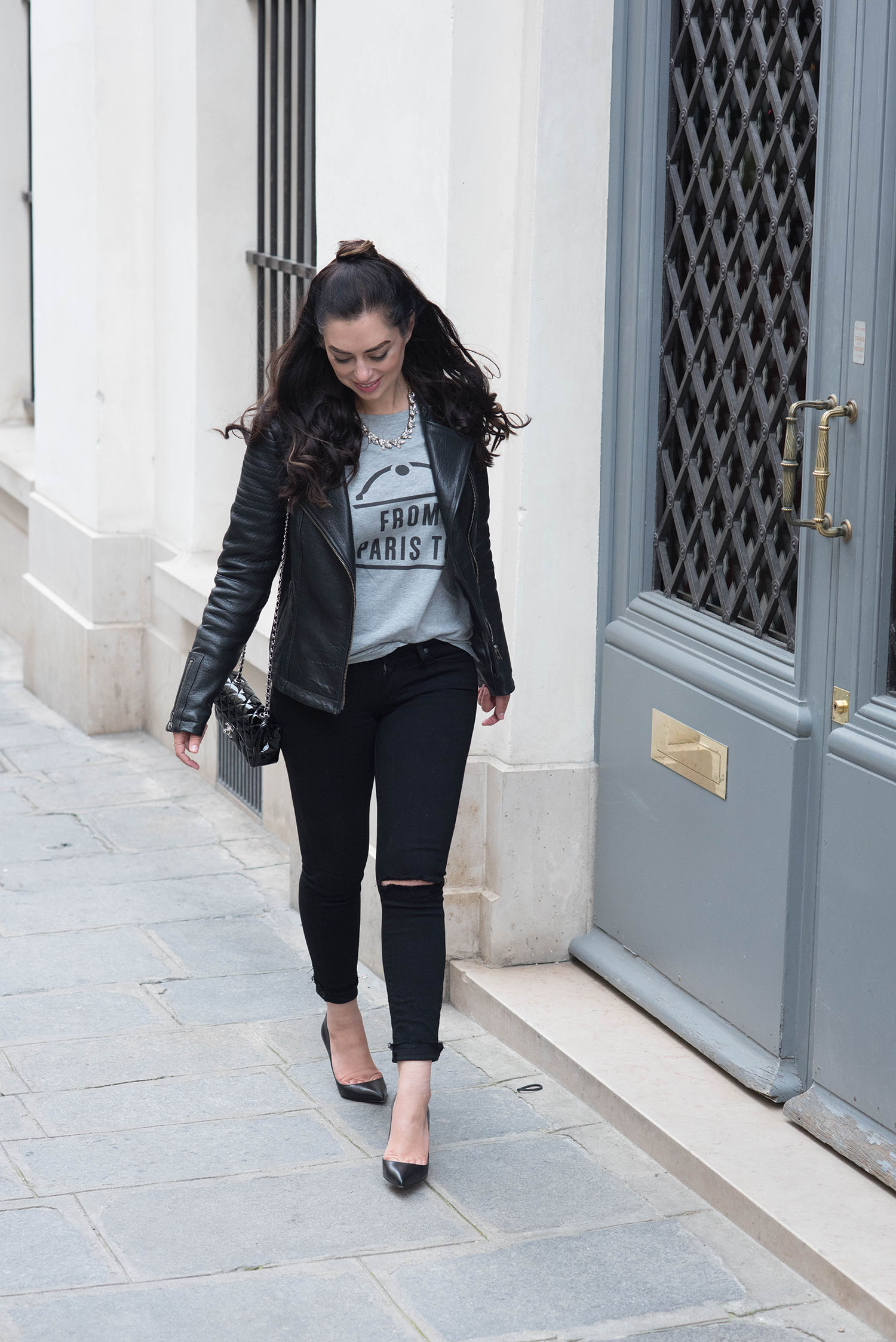 Fashion blogger Cee Fardoe of Coco & Vera walks in Paris wearing a Floriane Fosso From Paris To... t-shirt and carrying a Chanel Timeless handbag