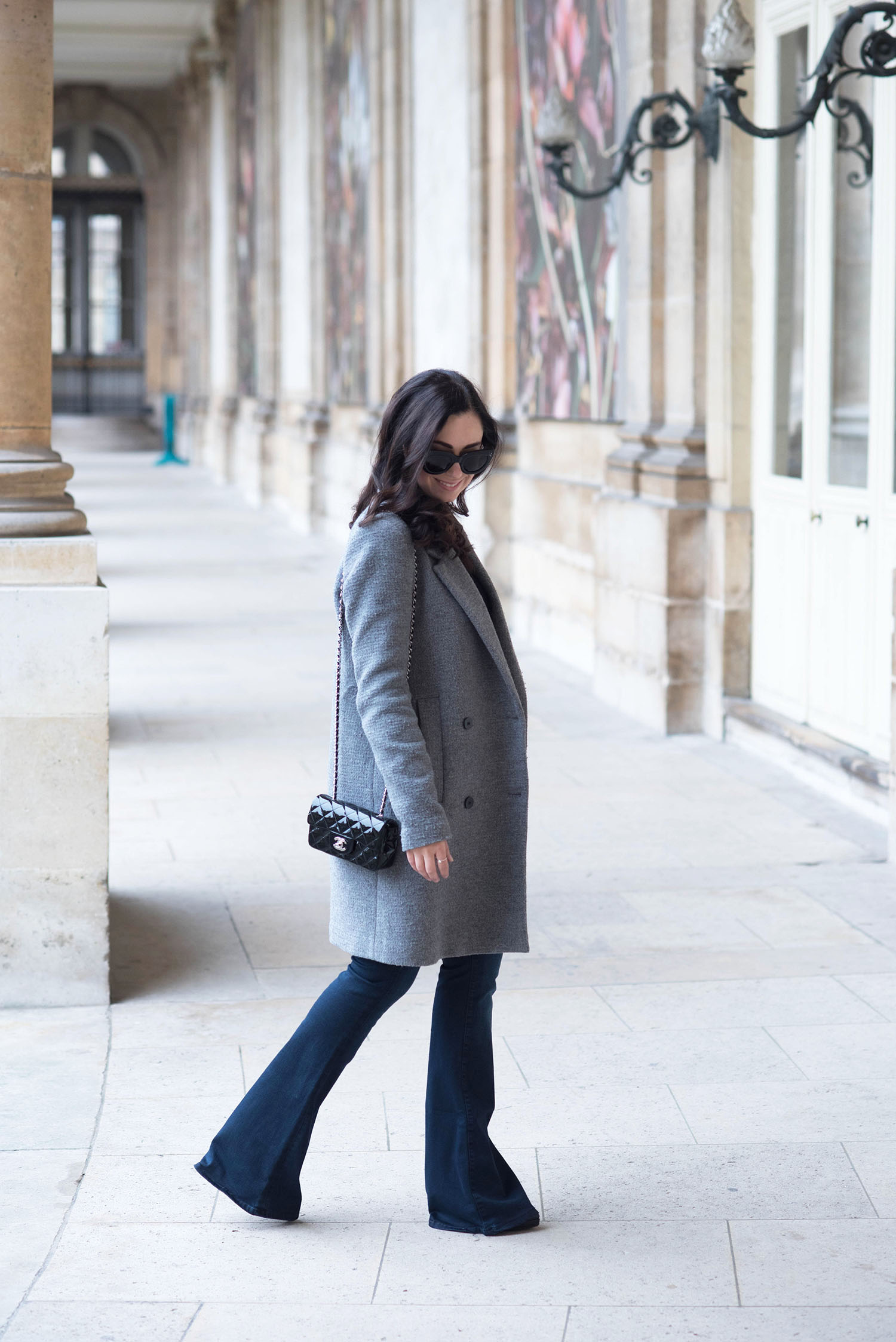 Fashion blogger Cee Fardoe of Coco & Vera at the National Archives in Paris, wearing Mavi flared jeans and carrying a Chanel Timeless handbag