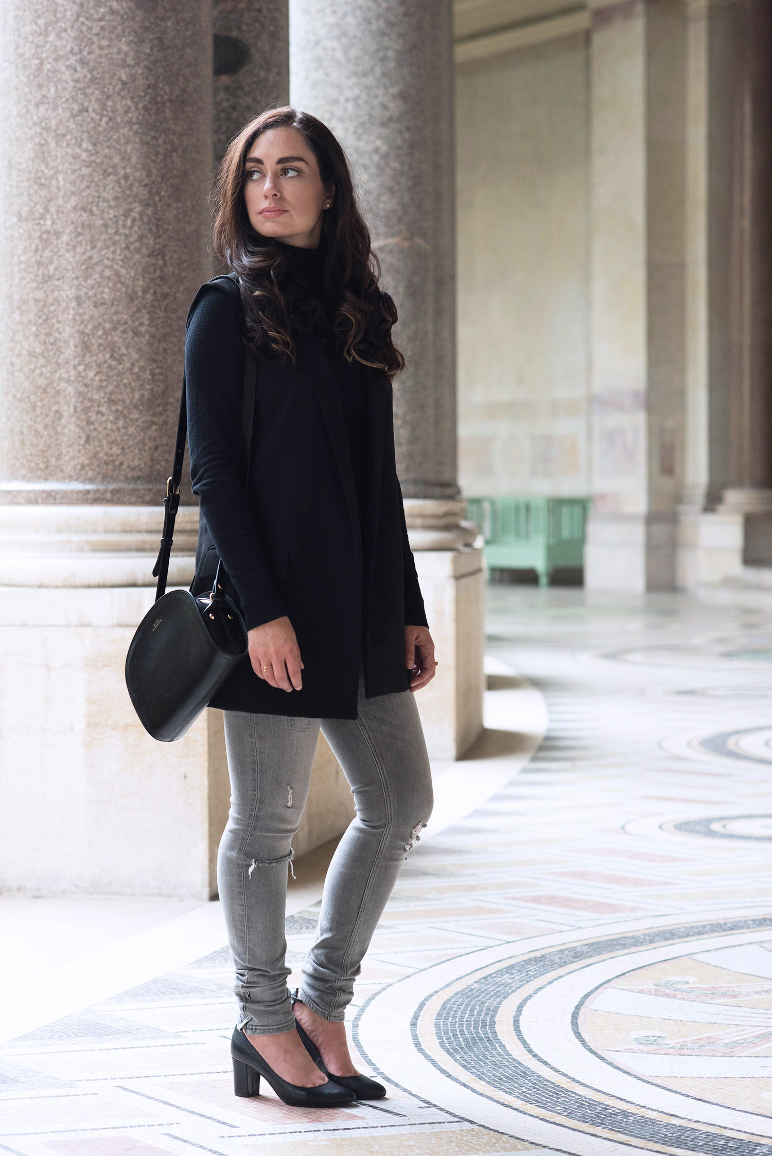 Style blogger Cee Fardoe of Coco & Vera at the Petit Palais in Paris wearing a black Zara waistcoat and carrying an APC half moon bag
