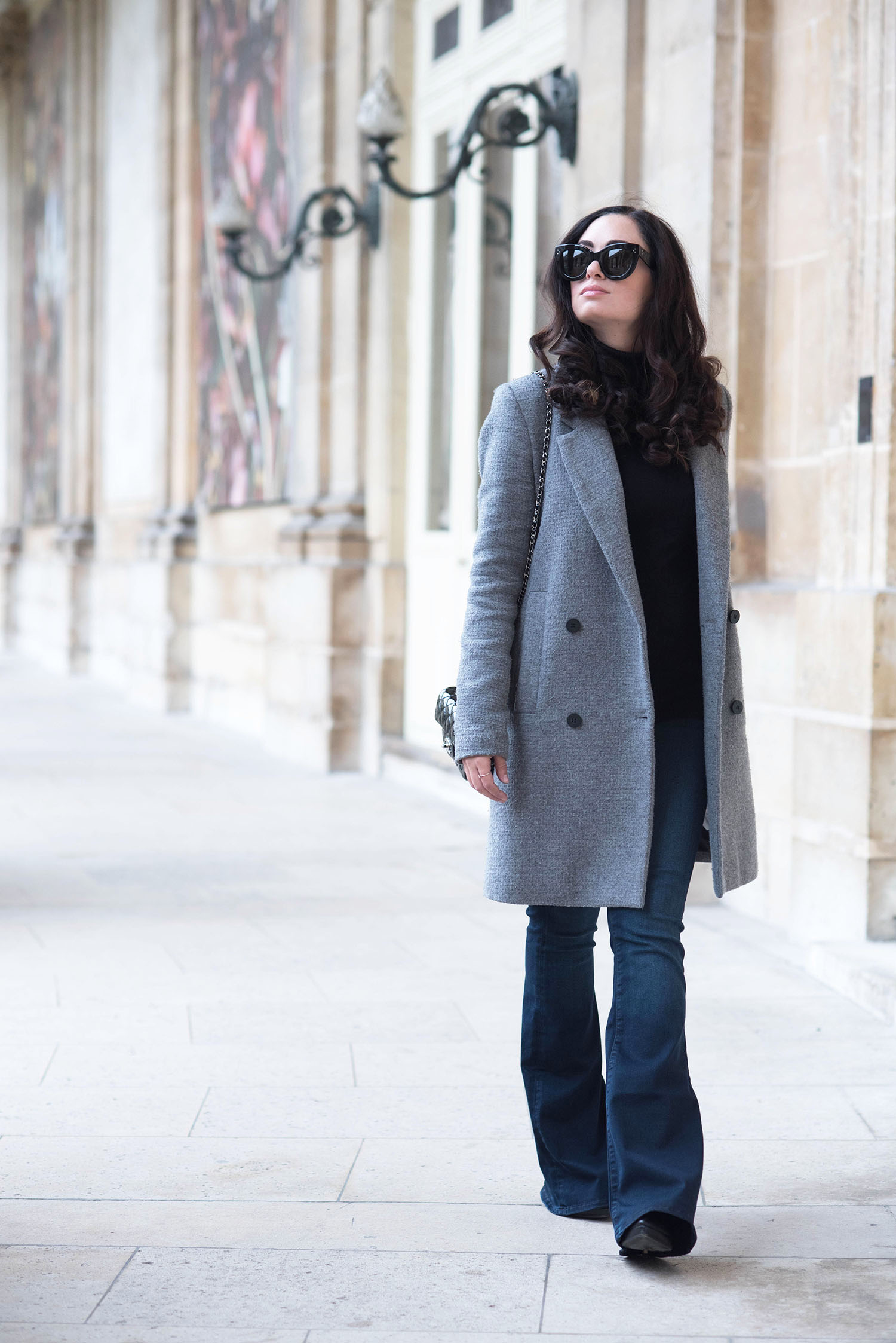 Canadian fashion blogger Cee Fardoe of Coco & Vera at the Archives Nationales in Paris wearing Mavi flared jeans and a Zara grey coat