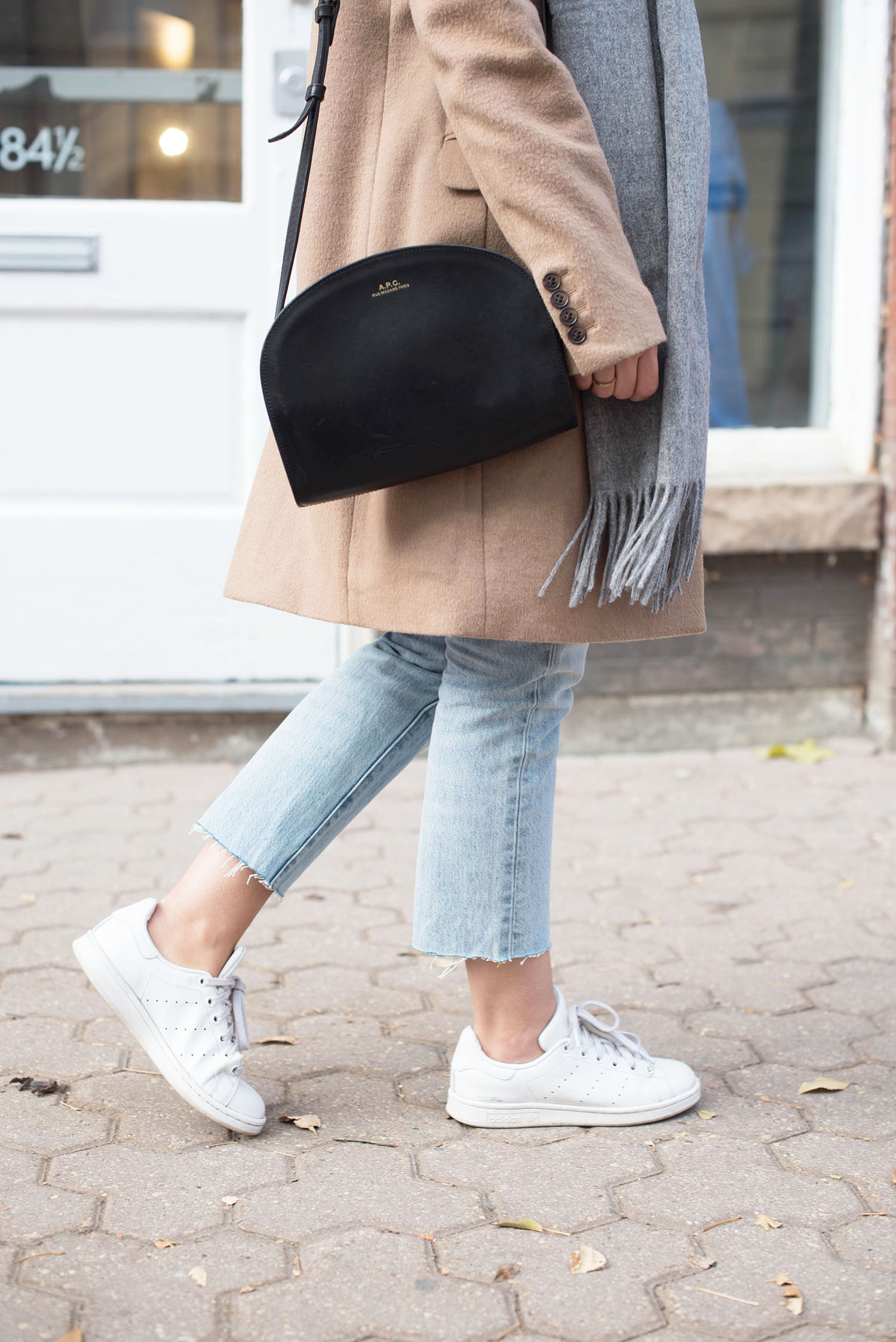 Outfit details on fashion blogger Cee Fardoe of Coco & Vera, including an APC halfmoon bag and Adidas Stan Smith sneakers