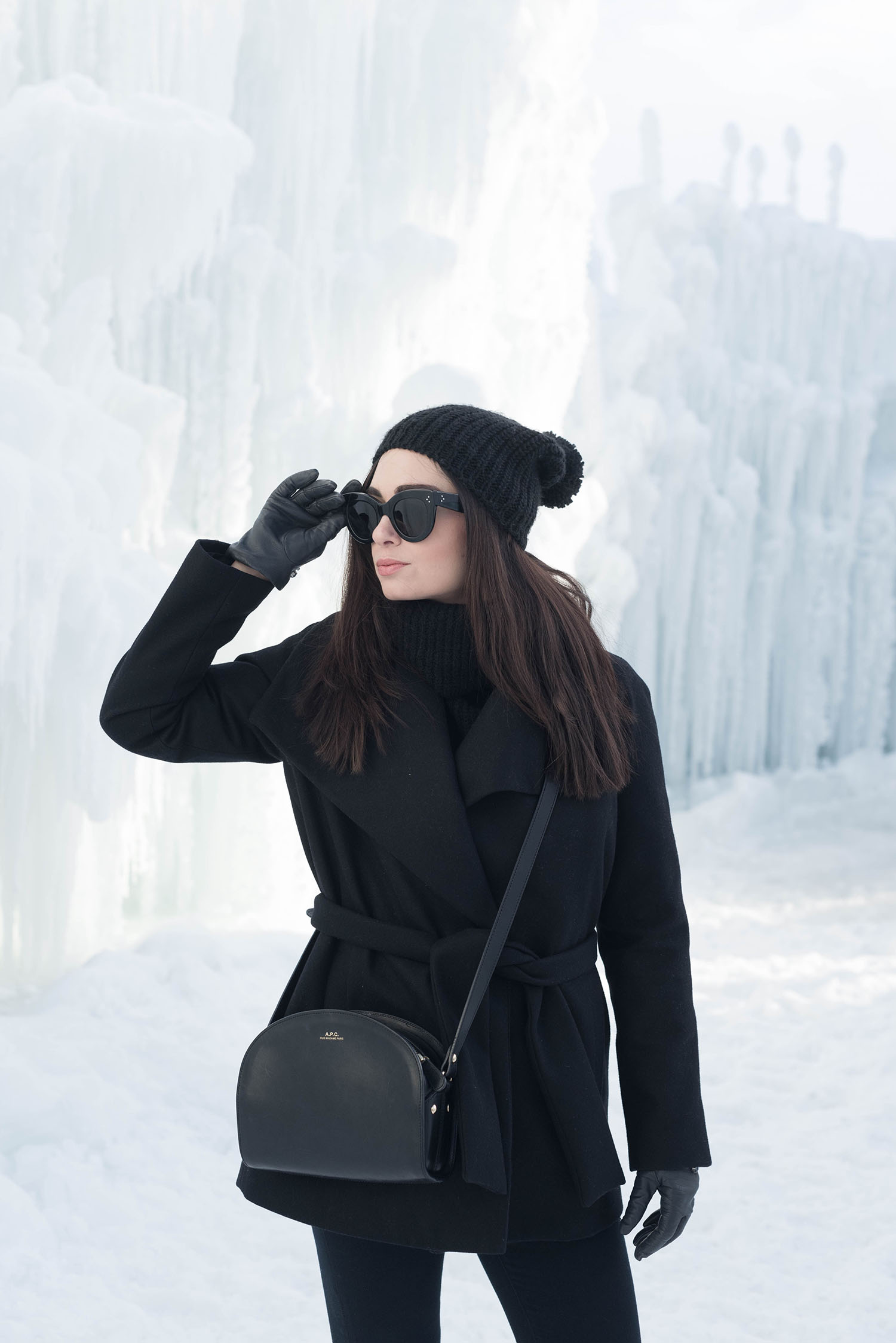 Portrait of Canadian fashion blogger Cee Fardoe at Ice Castles at the Forks in Winnipeg, wearing Celine Audrey sunglasses and a Mavi pompom hat
