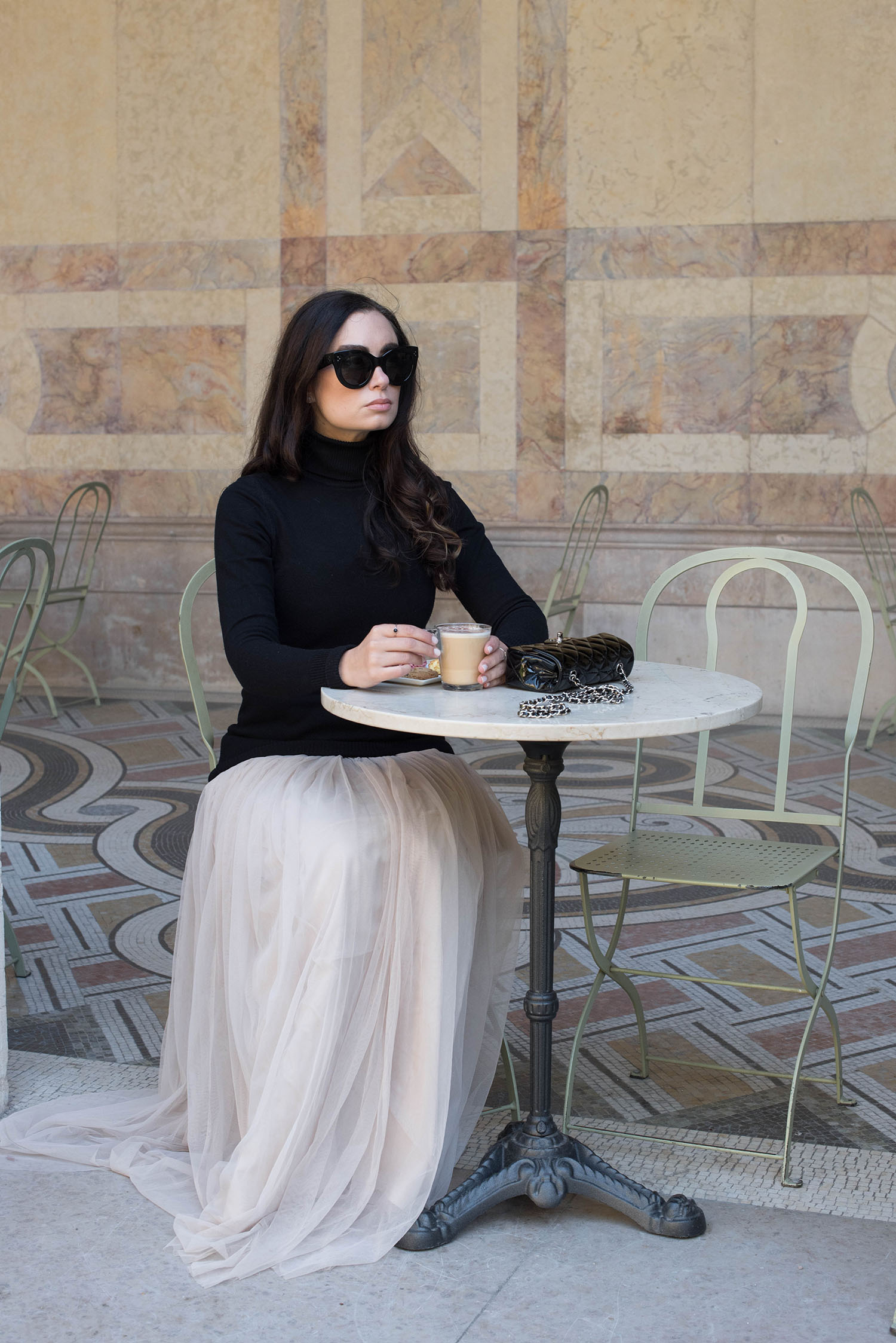 Winnipeg fashion blogger Cee Fardoe of Coco & Vera sits in the Petit Palais in Paris wearing a Le Chateau turtleneck sweater and a Needle & Thread dress