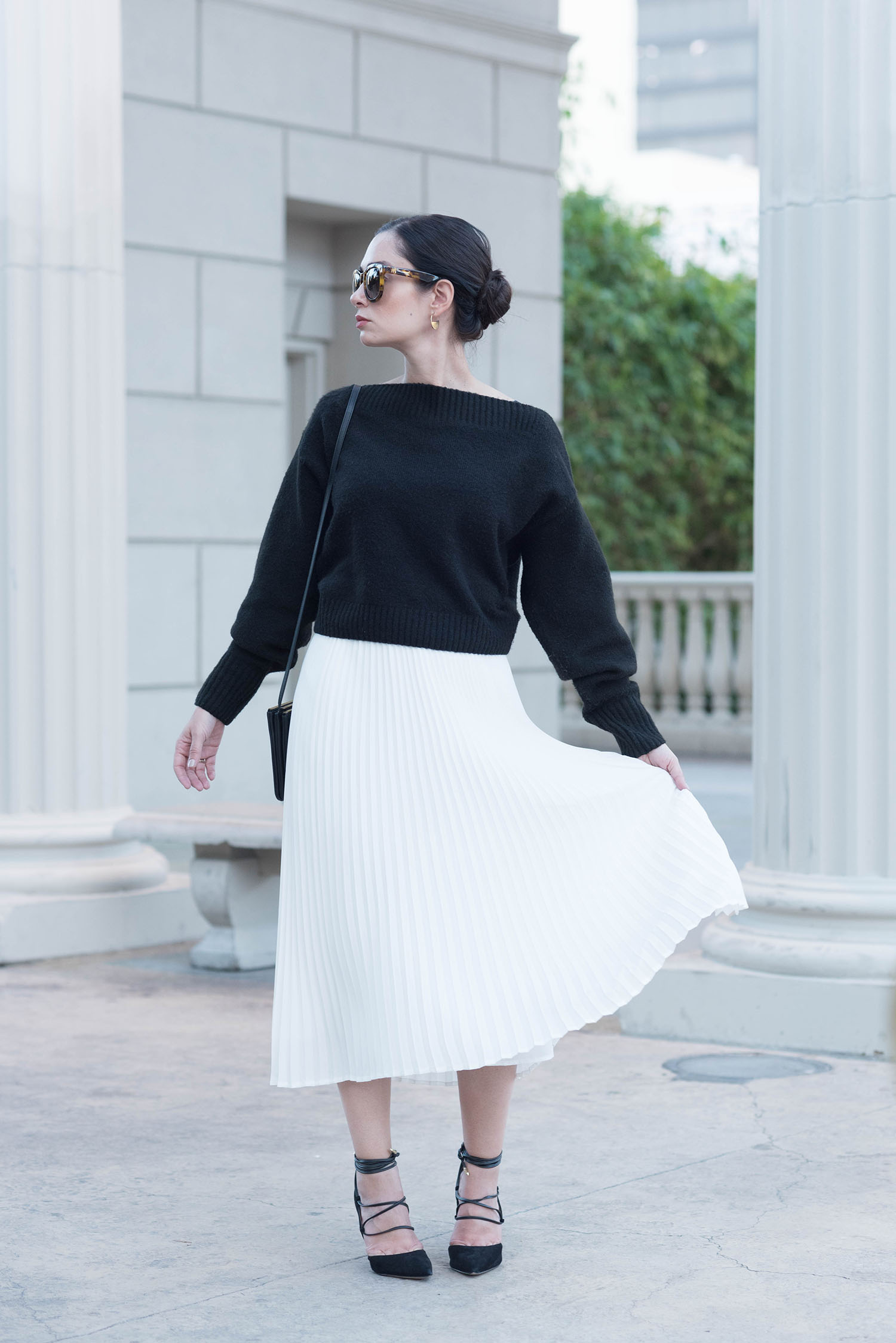 Fashion blogger Cee Fardoe of Coco & Vera at Caesar's Palace in Las Vegas wearing a white pleated Aritzia accurst and Sam Edelman lace-up heels