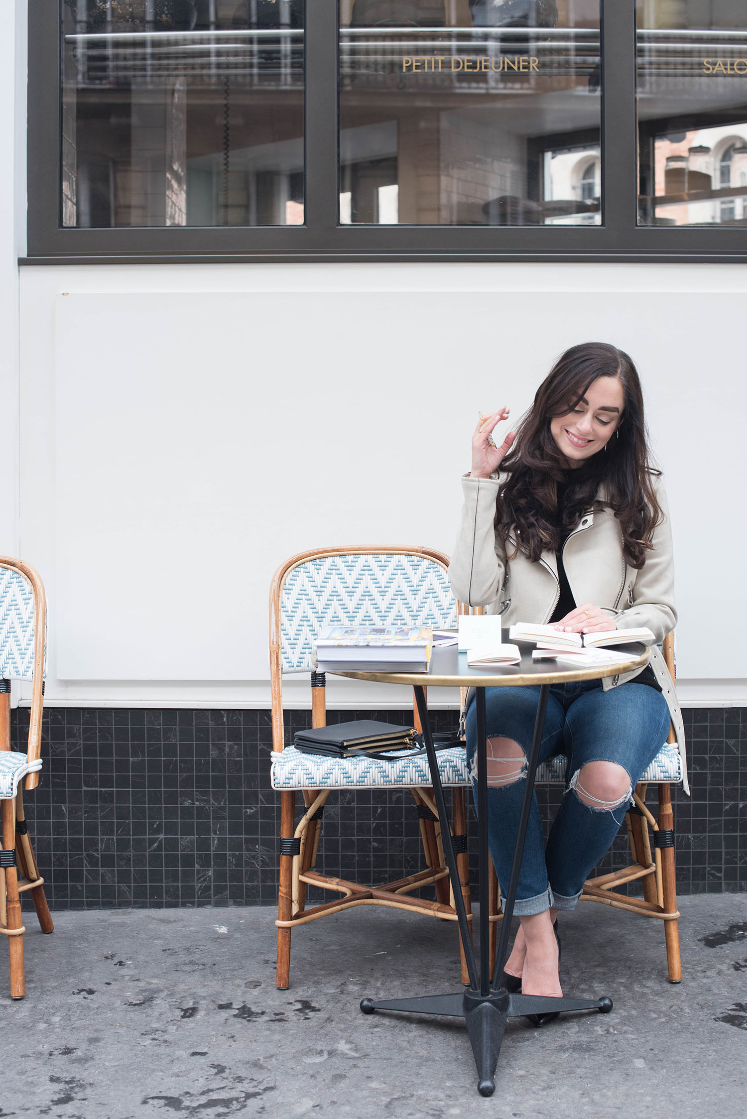 Winnipeg fashion blogger Cee Fardoe of Coco & Vera sits at cafe Maison Marie in Paris for an interview with The Plannerist, wearing a Zara suede jacket and Paige jeans