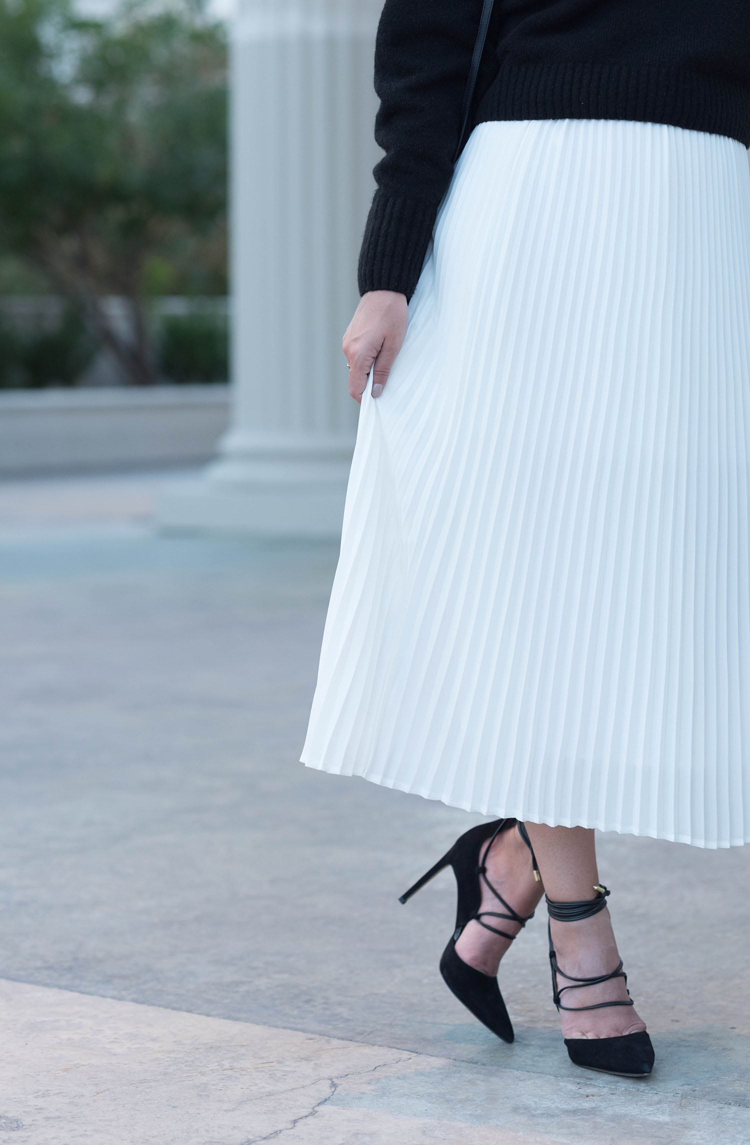 Outfit details on Winnipeg fashion blogger Cee Fardoe of Coco & Vera, including a white pleated skirt form Aritzia and Sam Edelman lace-up heels