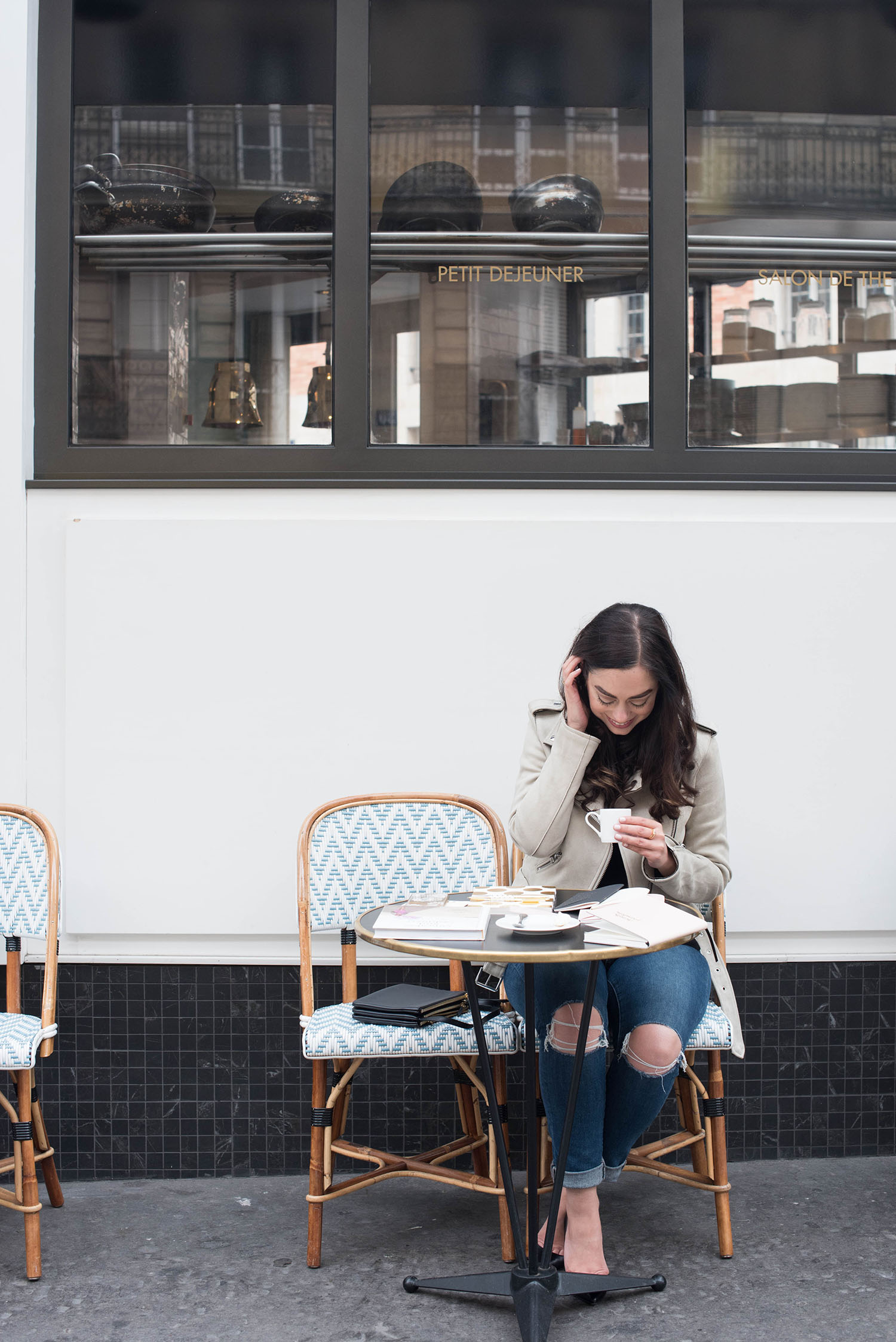 Winnipeg fashion blogger Cee Fardoe of Coco & Vera sits outside Cafe Maison Marie in Paris, drinking coffee during her interview with The Plannerist