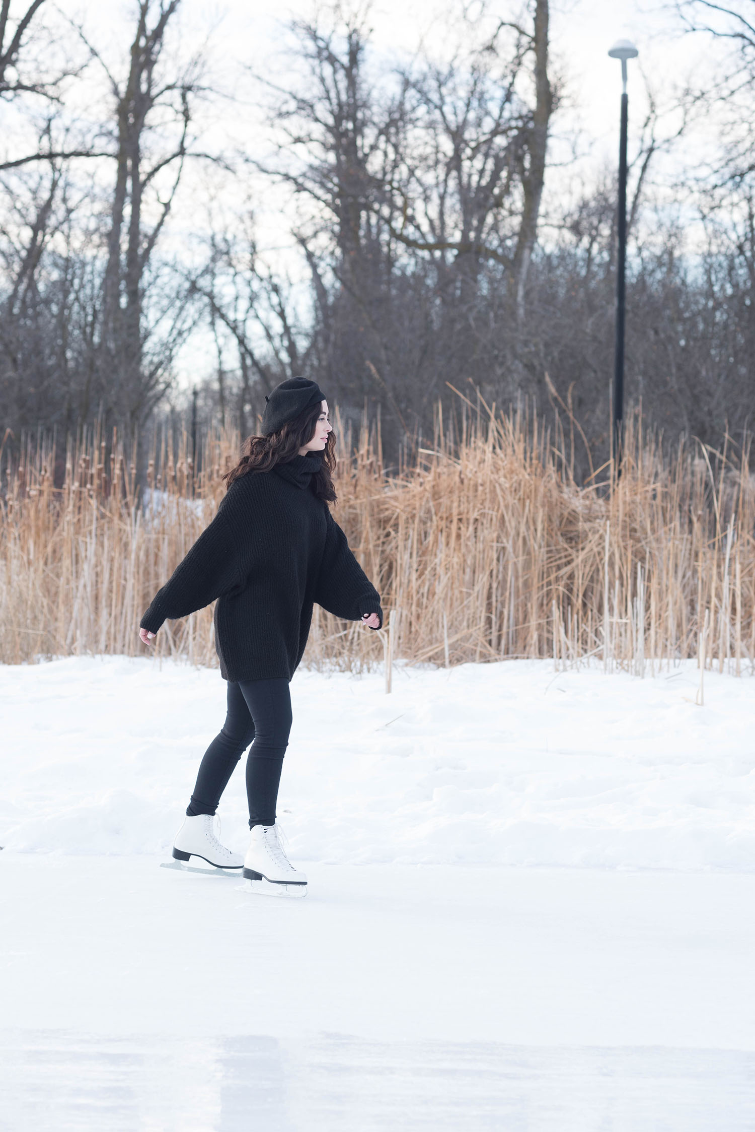 Canadian fashion blogger Cee Fardoe of Coco & Vera skates at Assiniboine Park wearing black Mavi jeans and a Zara sweater