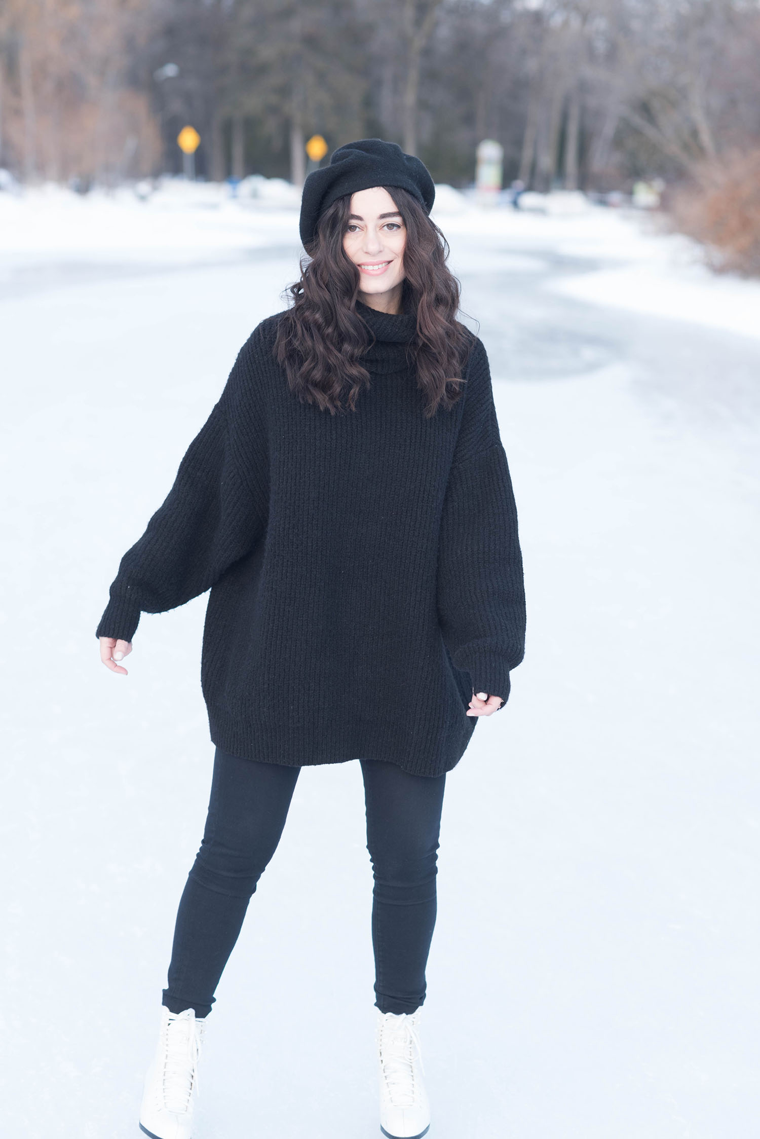 Canadian fashion blogger Cee Fardoe of Coco & Vera goes ice skating in Winnipeg wearing a black Zara sweater and black Anthropologie beret